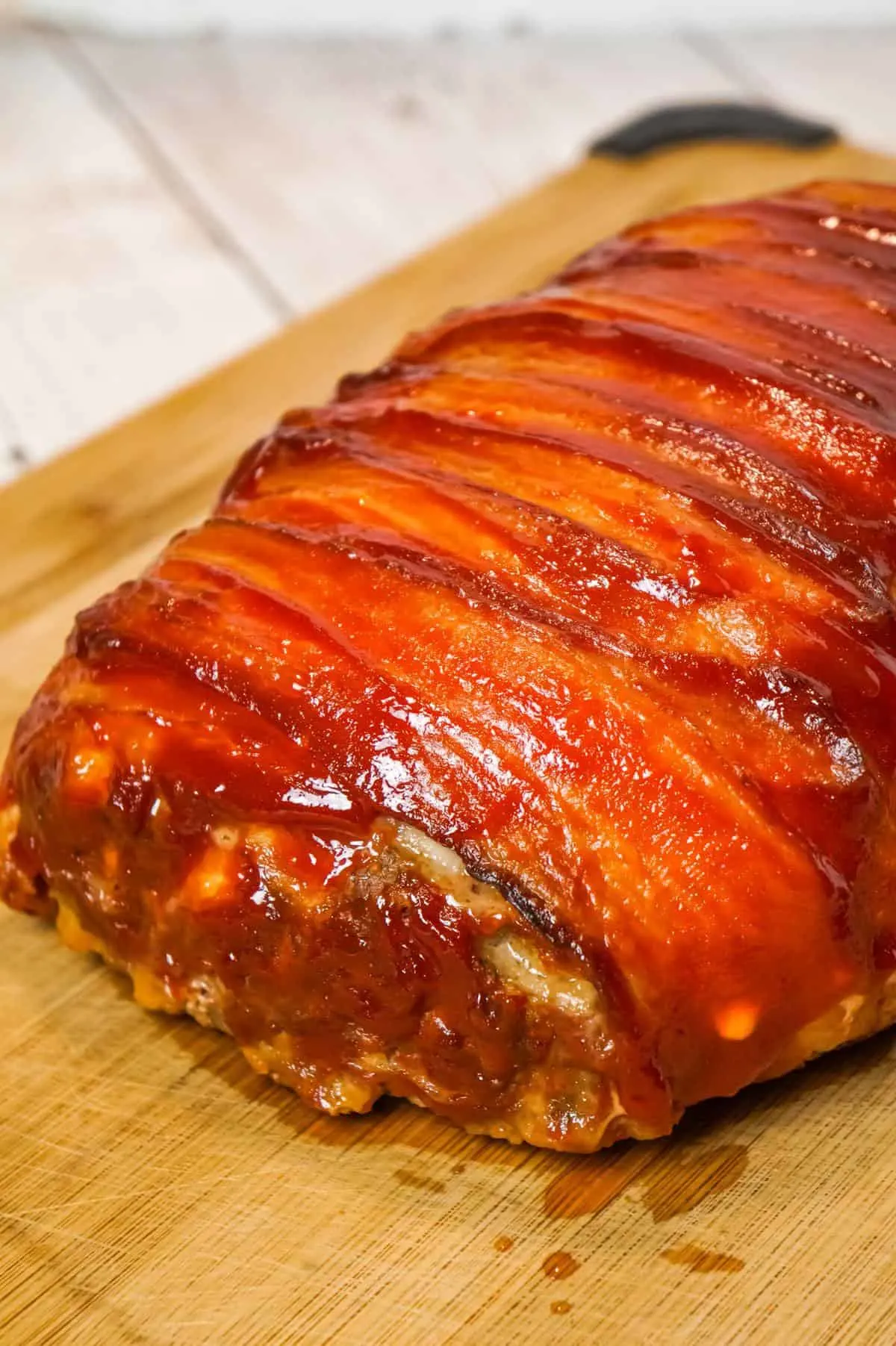 Bacon Wrapped Meatloaf is a delicious ground beef meatloaf with a ketchup glaze wrapped in strips of bacon.