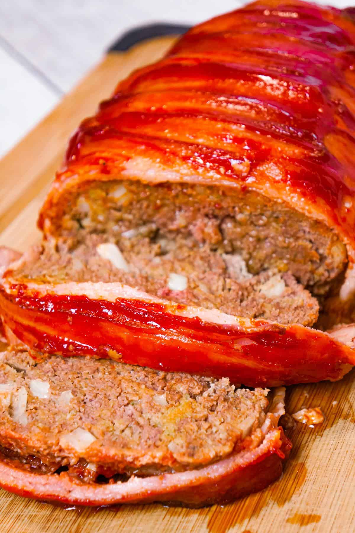 Bacon Wrapped Meatloaf is a delicious ground beef meatloaf with a ketchup glaze wrapped in strips of bacon.