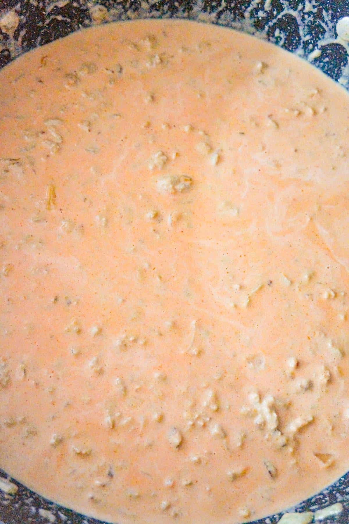 creamy tomato sauce and ground chicken mixture in a saute pan