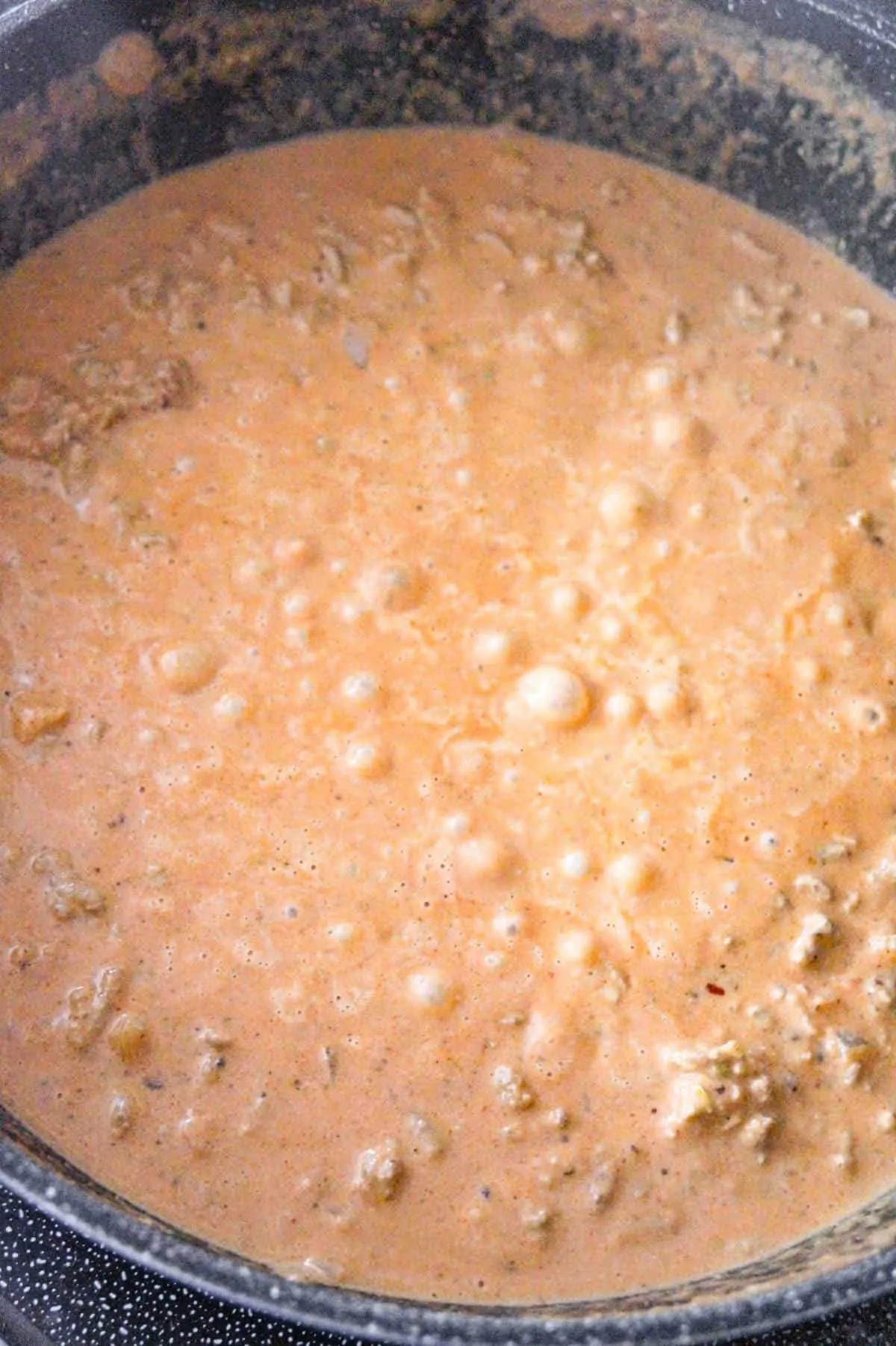 butter chicken sloppy joe mixture bubbling in a pan