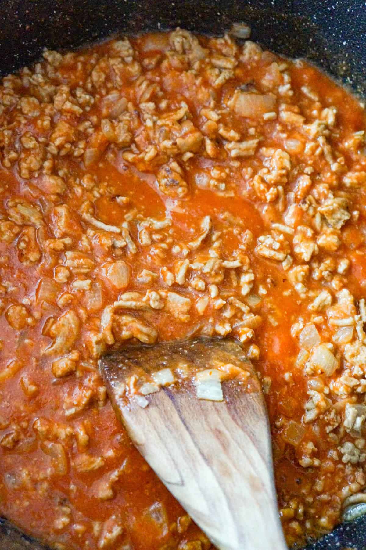 ground chicken and tomato sauce mixture in a saute pan