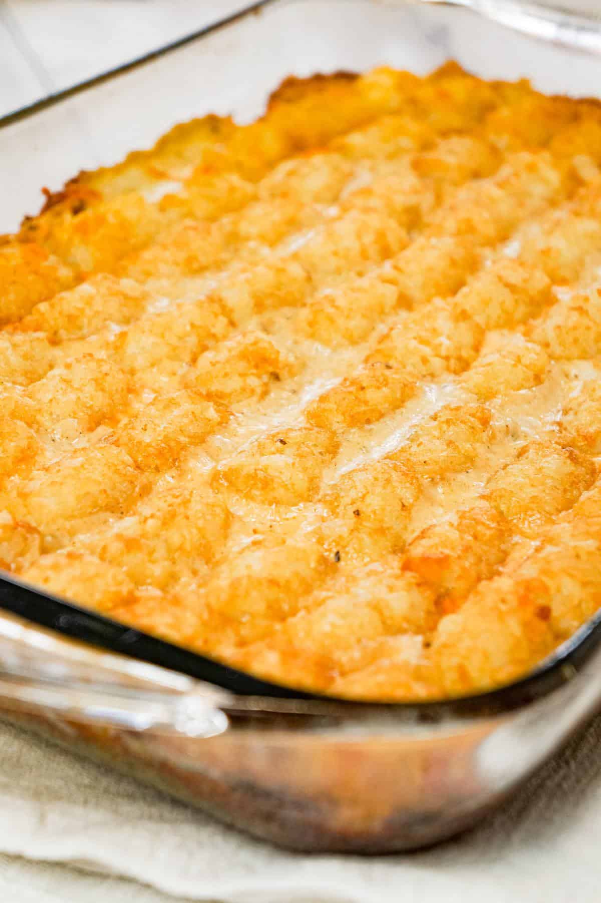 Green Bean Casserole with Tater Tots is an easy side dish recipe made with canned green beans and loaded with cream of mushroom soup, French's fried onions, shredded cheese and tater tots.