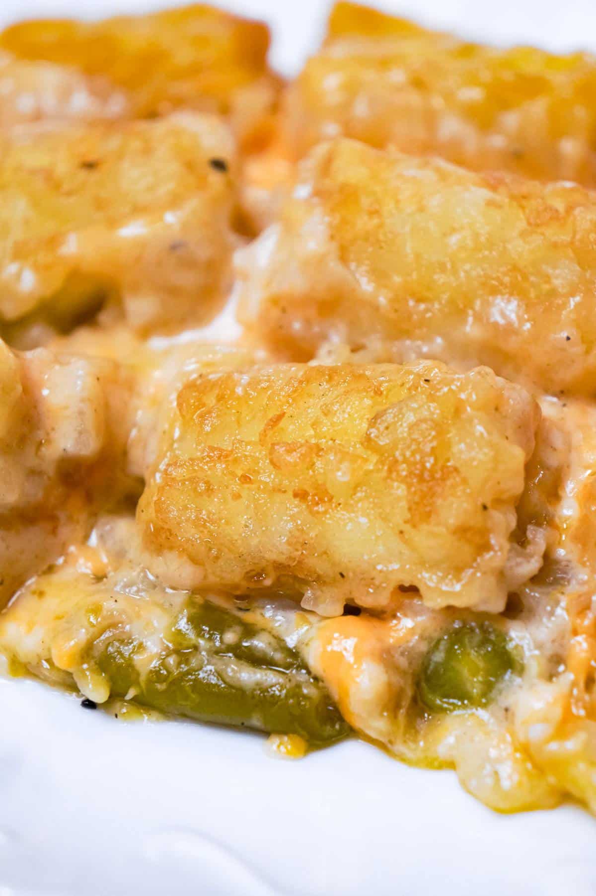 Green Bean Casserole with Tater Tots is an easy side dish recipe made with canned green beans and loaded with cream of mushroom soup, French's fried onions, shredded cheese and tater tots.