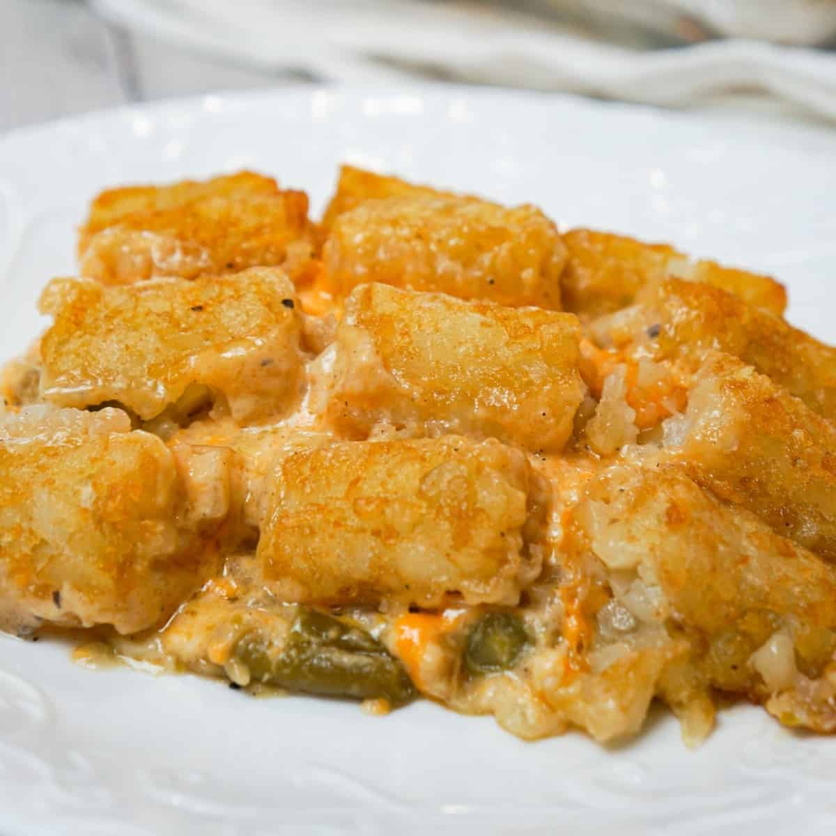 Green Bean Casserole with Tater Tots is an easy side dish recipe made with canned green beans and loaded with cream of mushroom soup, French's fried onions, shredded cheese and tater tots.