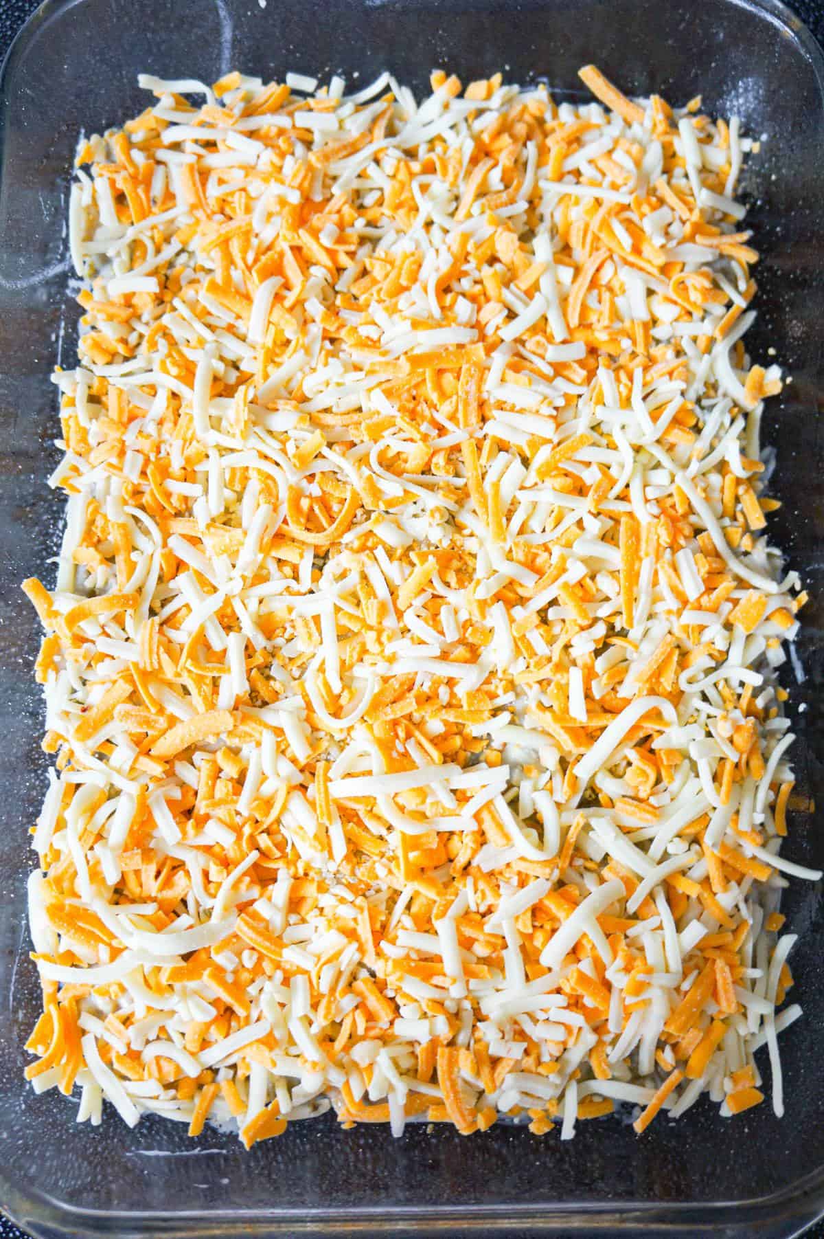 shredded cheese on top of green bean casserole
