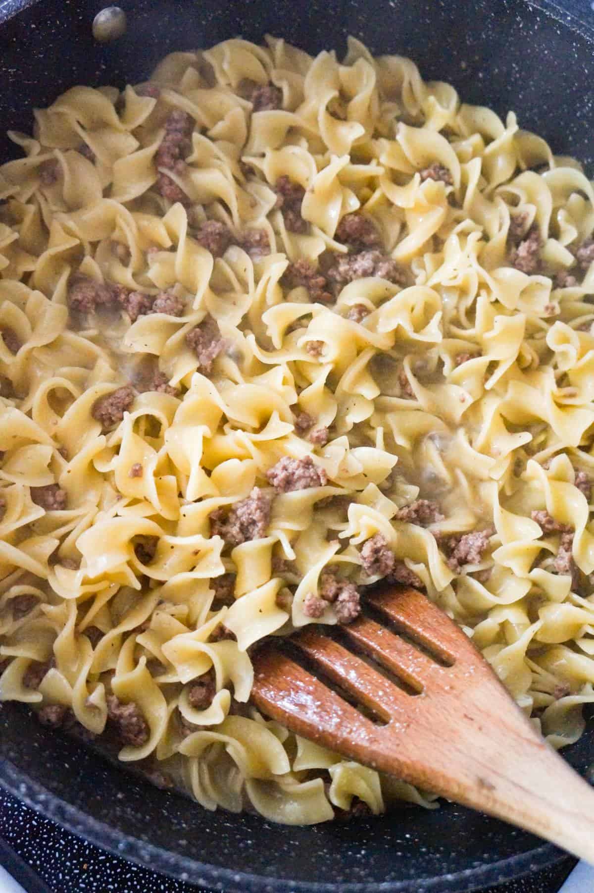 cooked ground beef and egg noodles in a pan