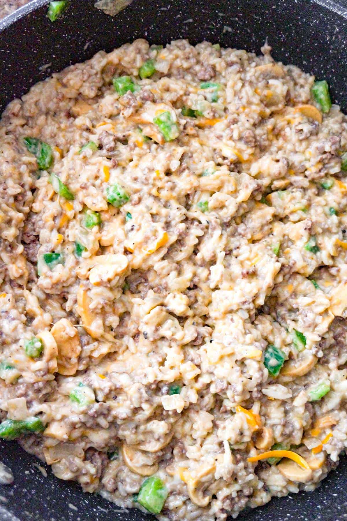 shredded cheese stirred into ground beef and rice