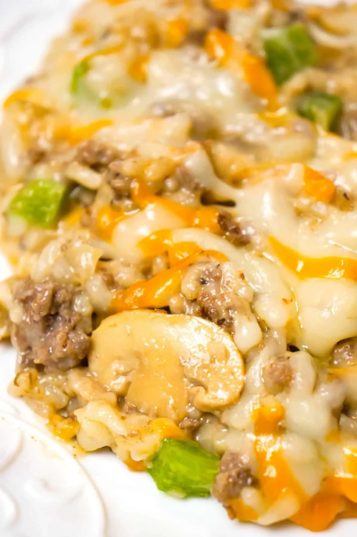 One Pot Philly Cheese Steak Ground Beef and Rice is an easy stove top dinner recipe loaded with hamburger meat, green peppers, sliced mushrooms, instant rice, cream of mushroom soup and shredded cheese.