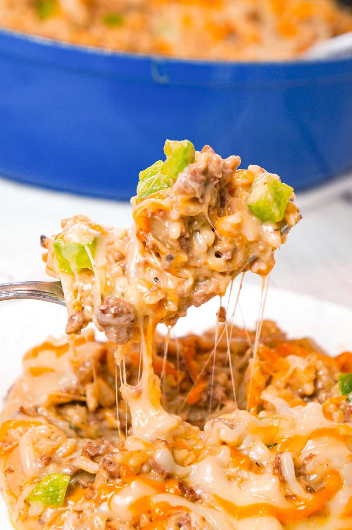 One Pot Philly Cheese Steak Ground Beef and Rice is an easy stove top dinner recipe loaded with hamburger meat, green peppers, sliced mushrooms, instant rice, cream of mushroom soup and shredded cheese.