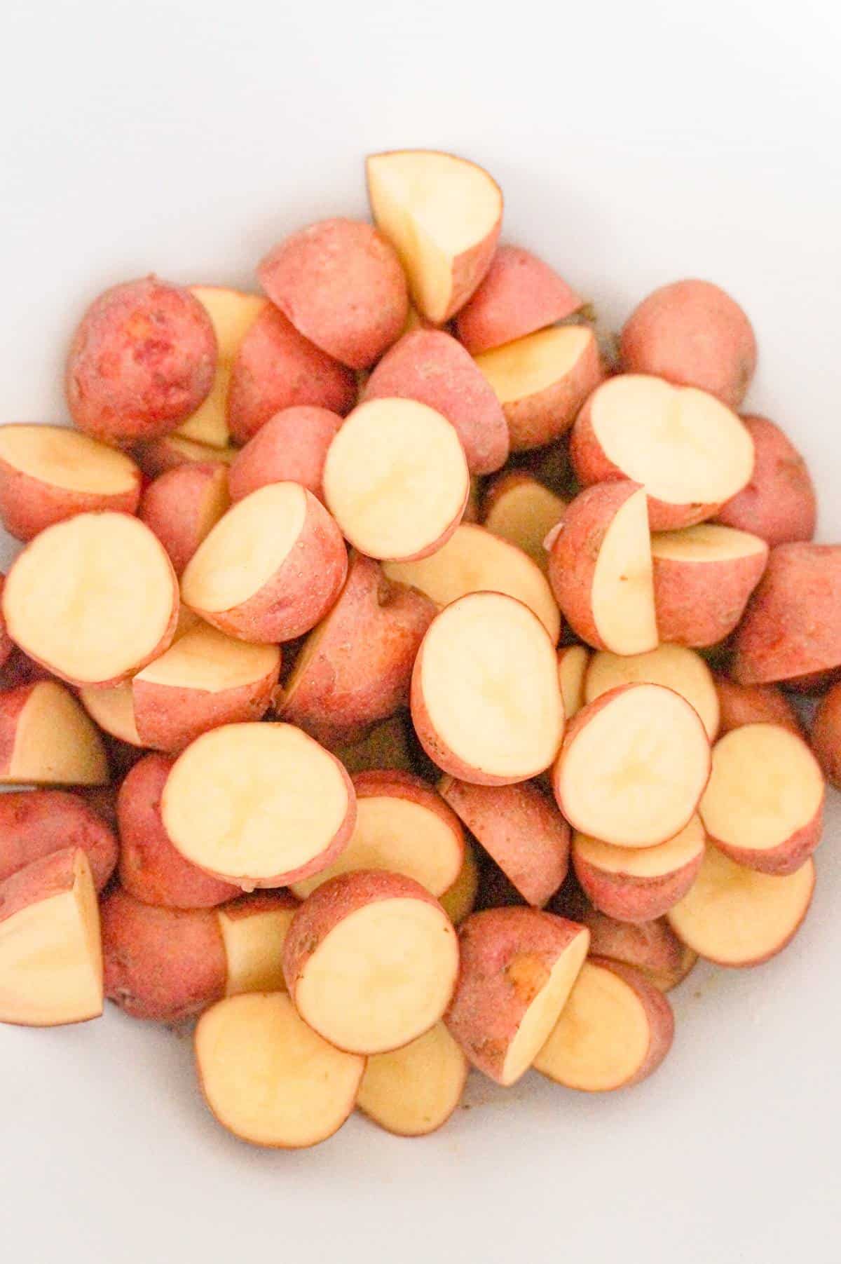 potato halves in a mixing bowl