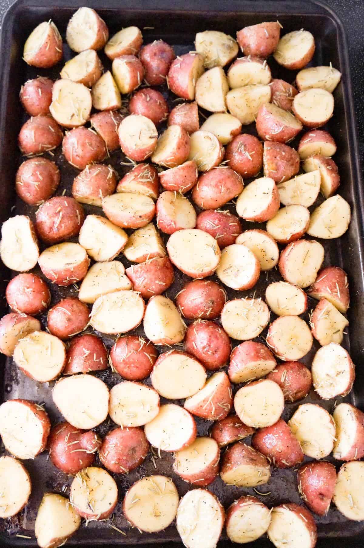 chopped red potatoes on a pan before baking