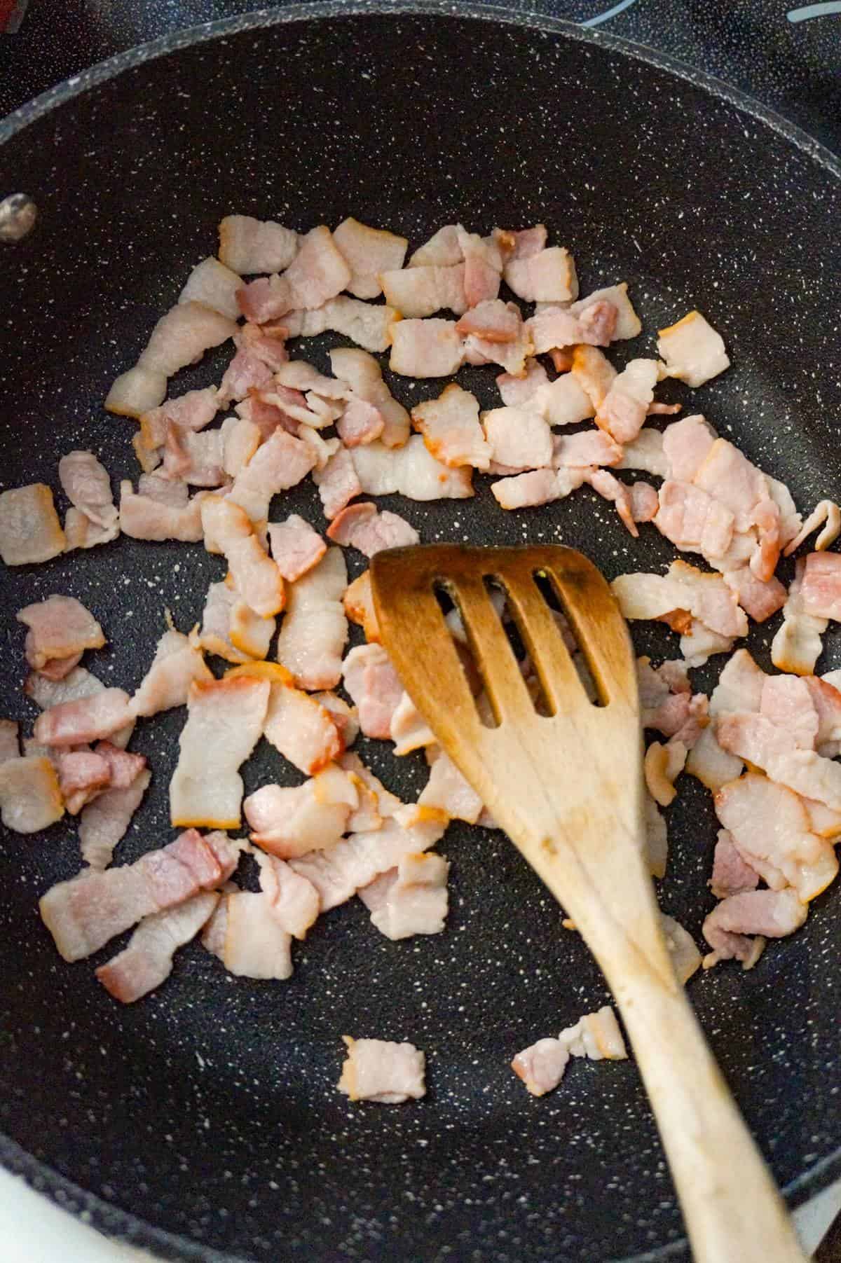 diced bacon pieces cooking in a saute pan
