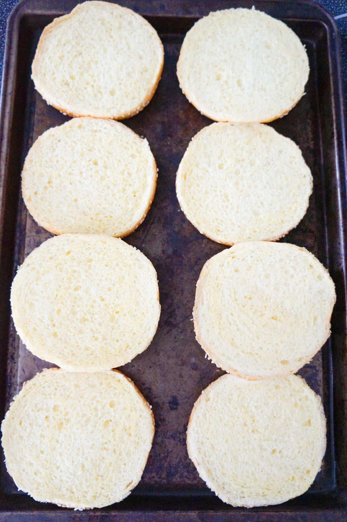Brioche buns on a baking sheet