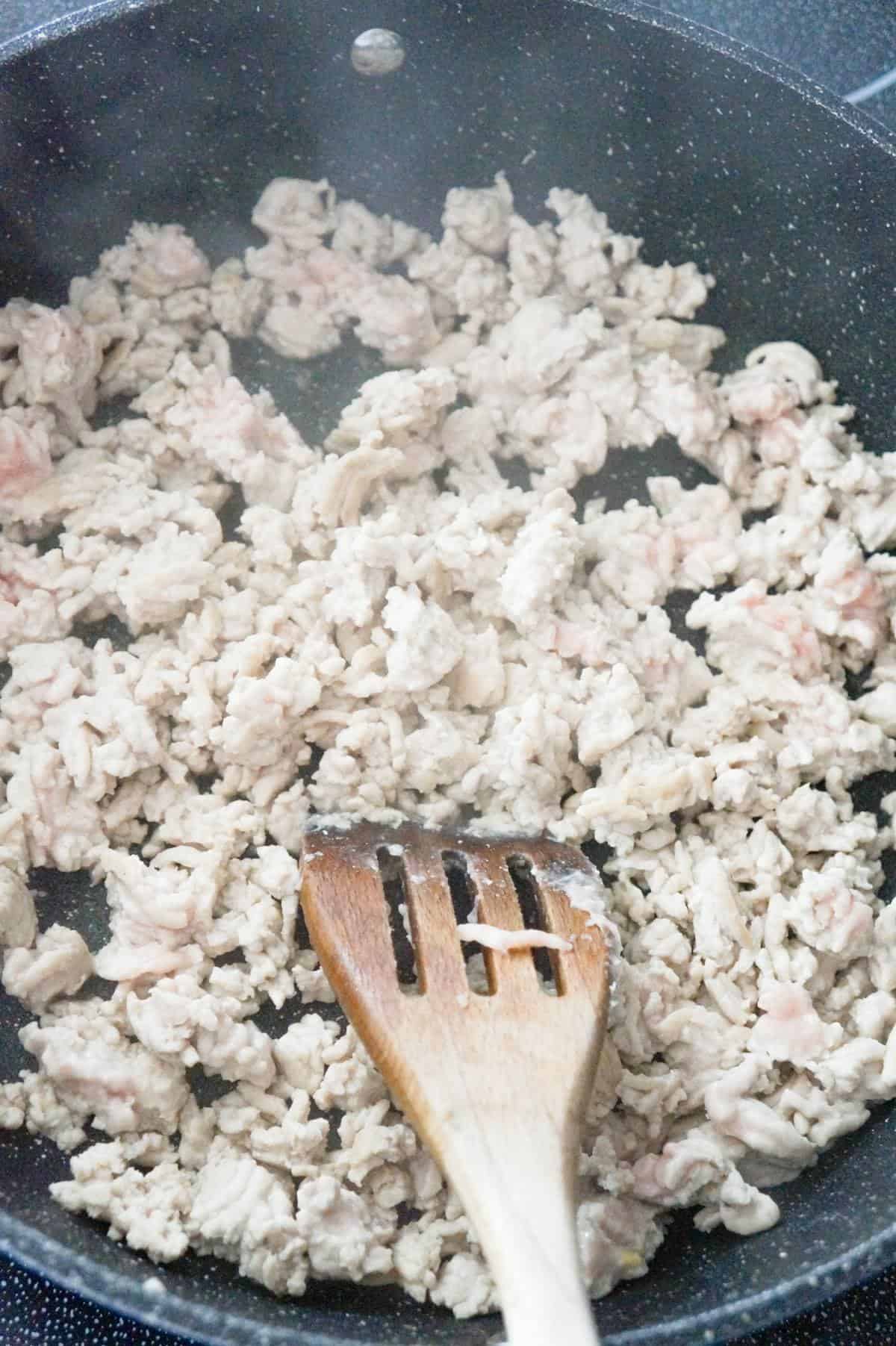 ground turkey cooking in saute pan