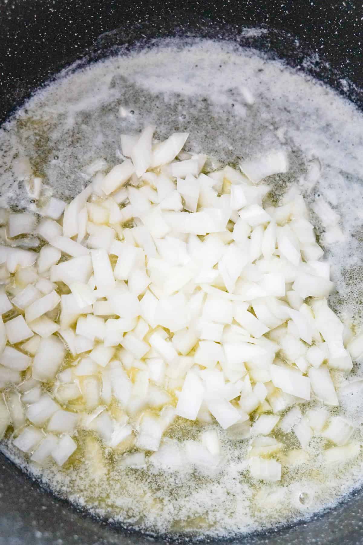 diced onions on top of melted butter in a large pot