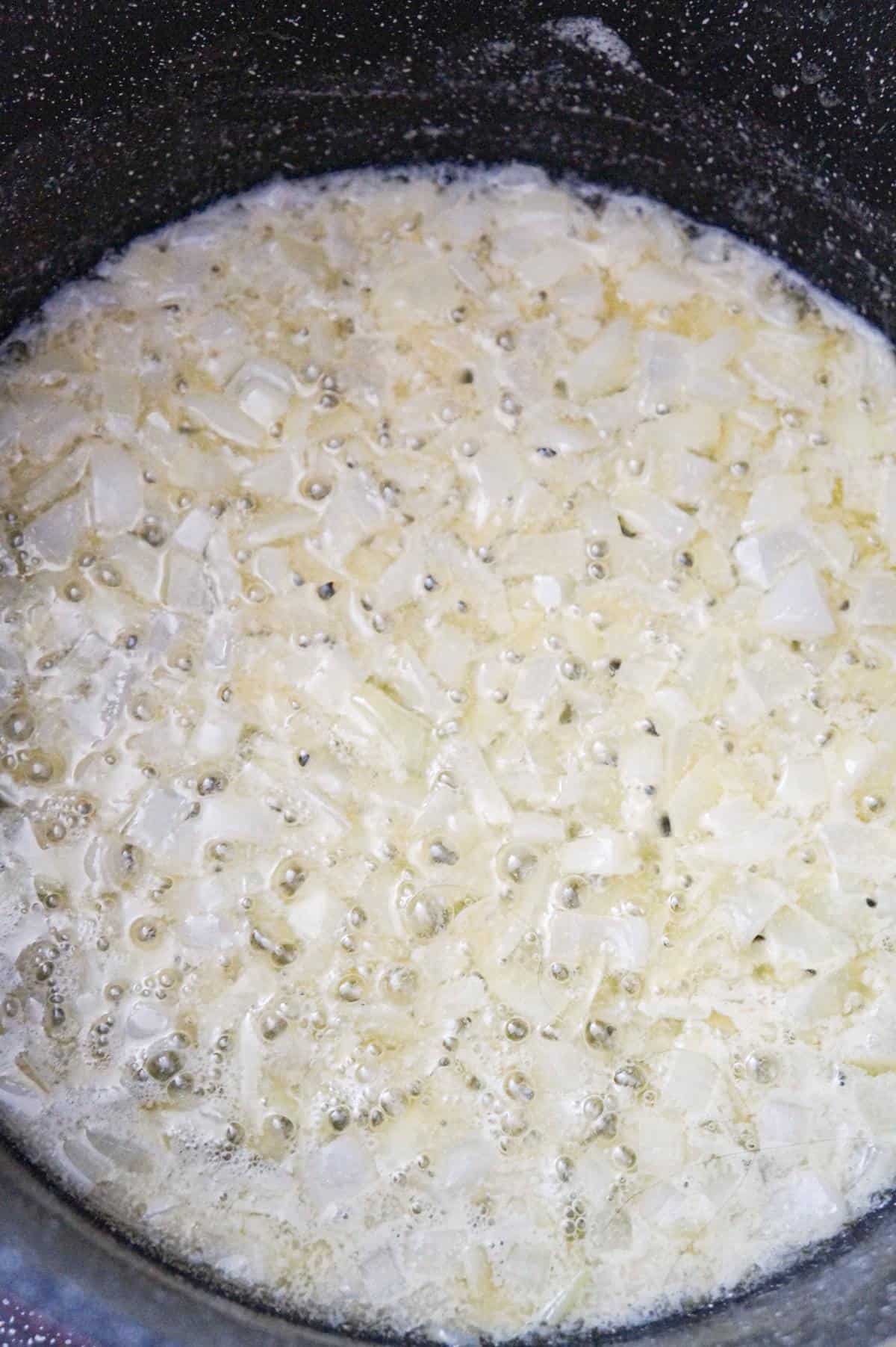 diced onions cooking in butter in a large pot