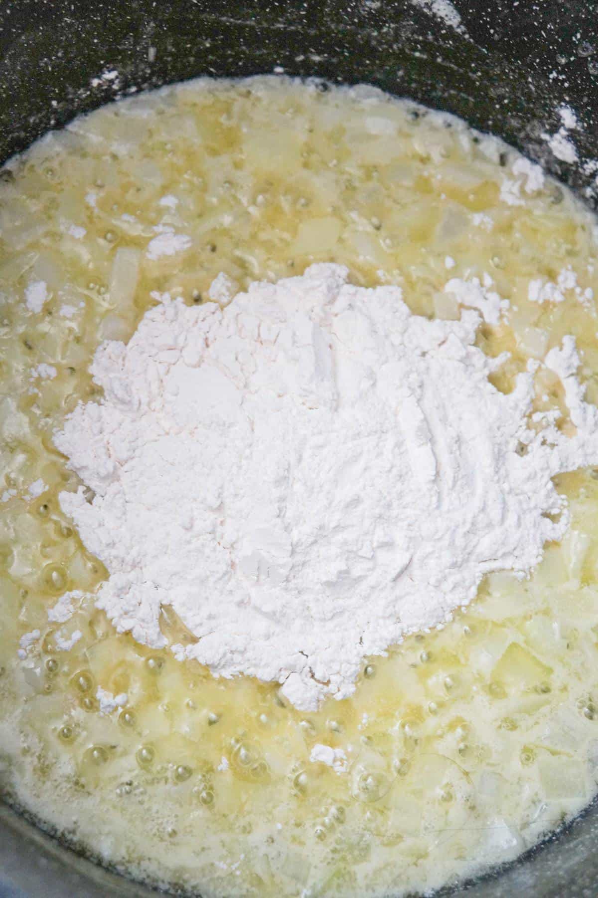 flour on top of butter and diced onions in a large pot