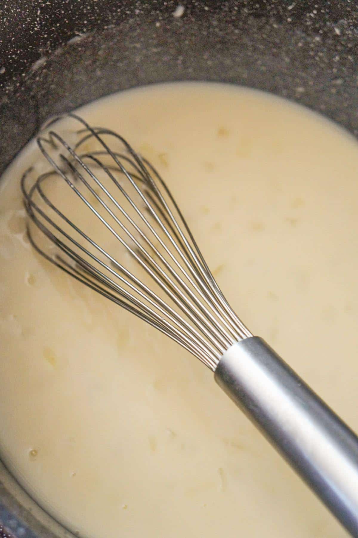 chicken broth whisked into butter and flour mixture in a large pot