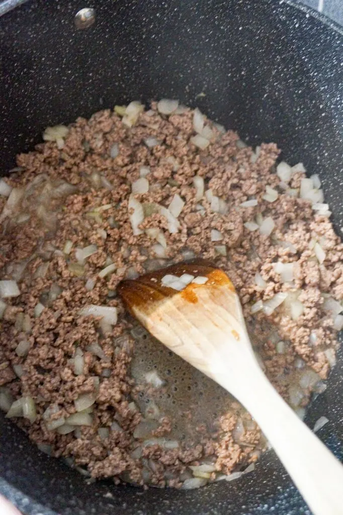 cooked ground beef and diced onions in a large pot