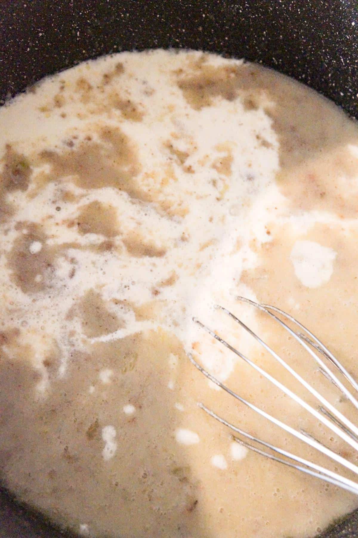 cream added to broth and ground beef mixture in a large pot