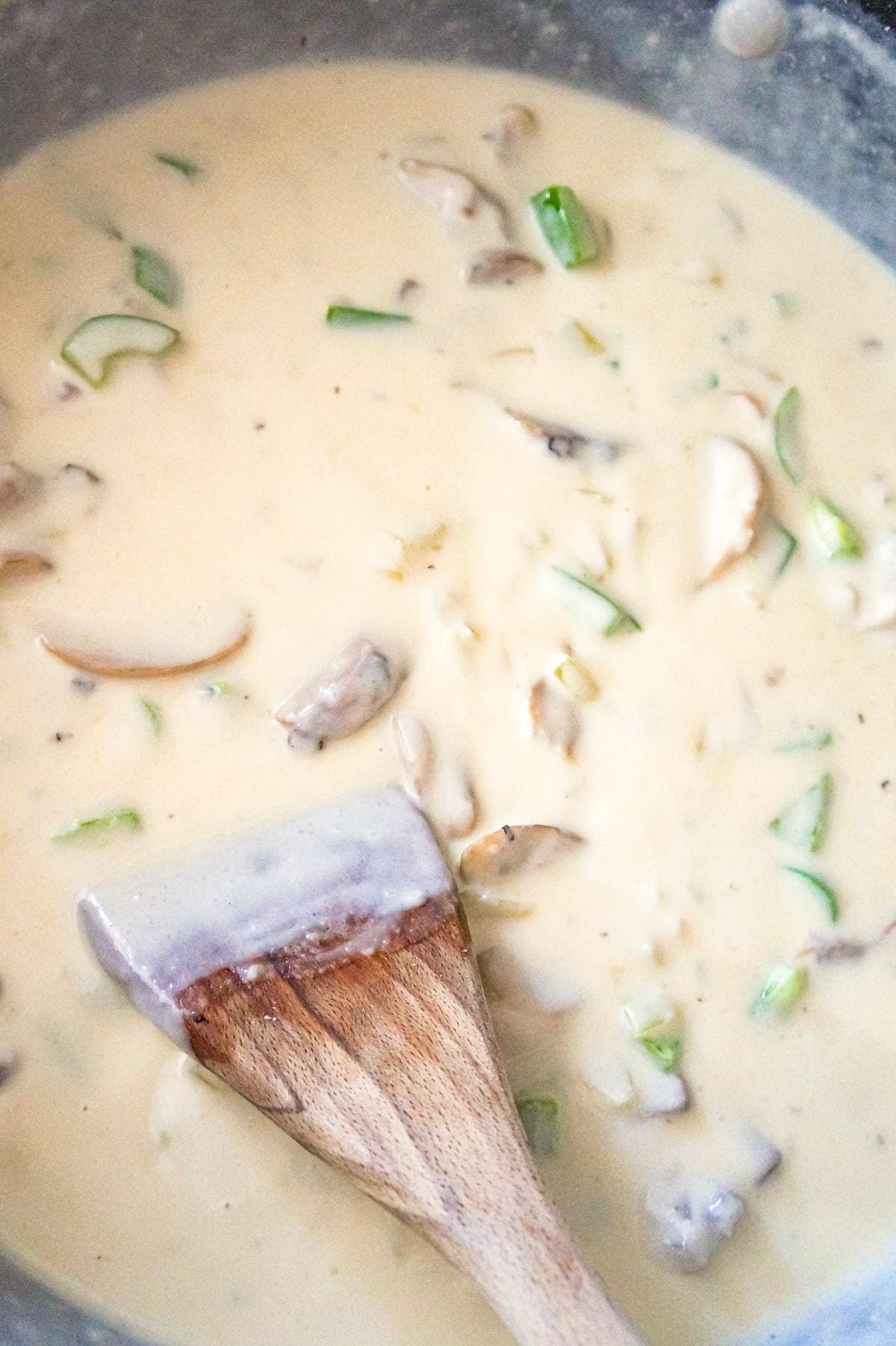 creamy sauce with sliced mushrooms and diced green peppers