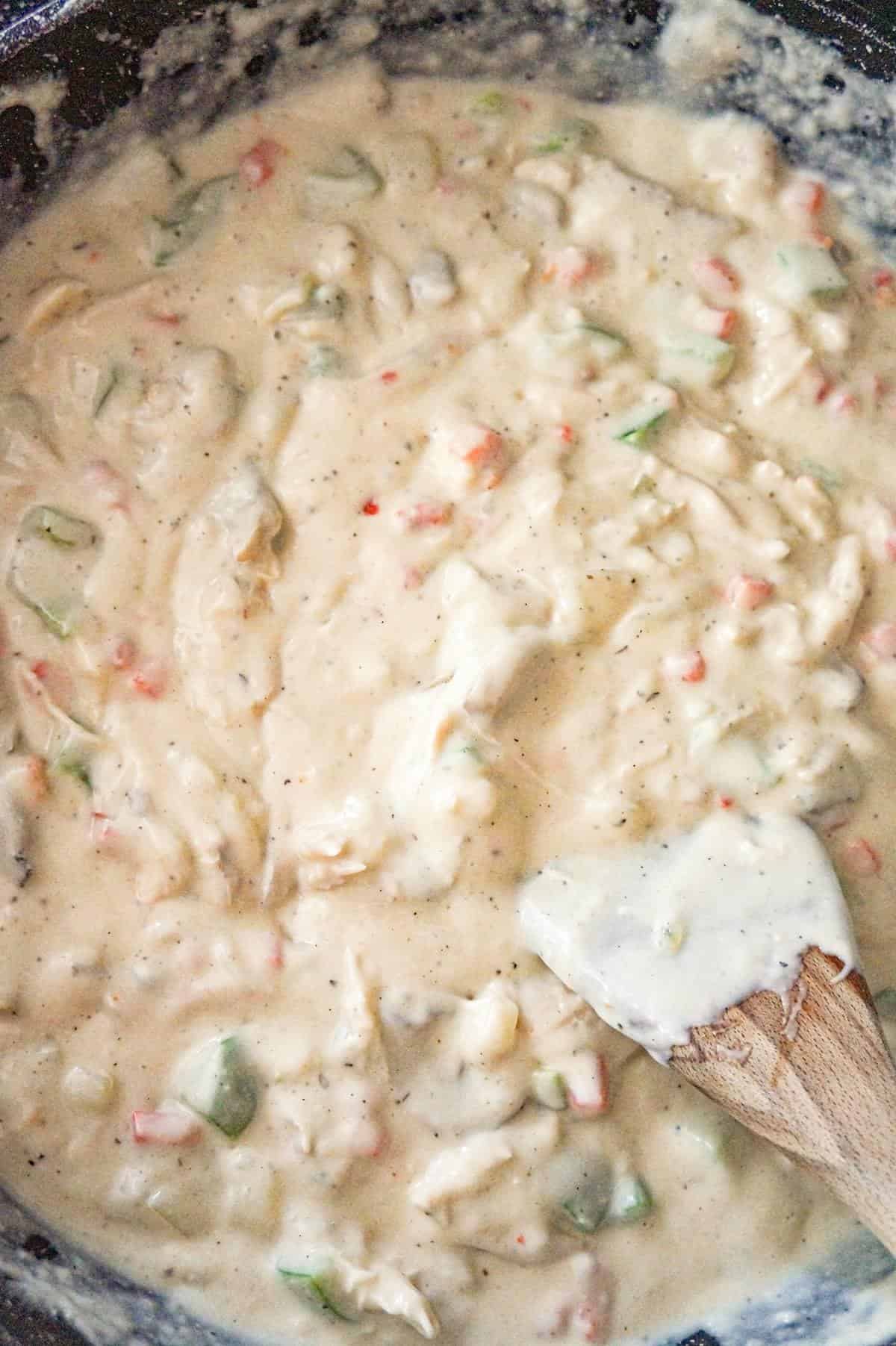 creamy chicken and vegetable mixture in a saute pan