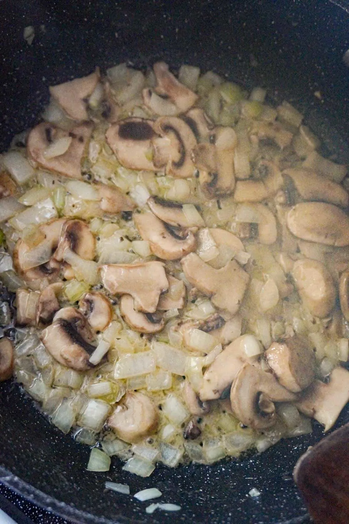 cooked onions and mushrooms in a saute pan