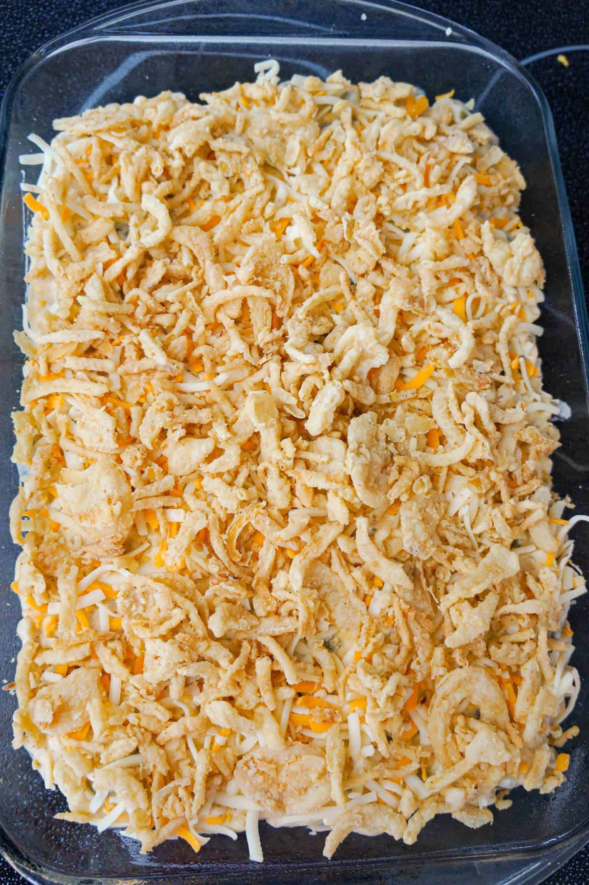 crispy fried onions on top of mac and cheese casserole with green beans