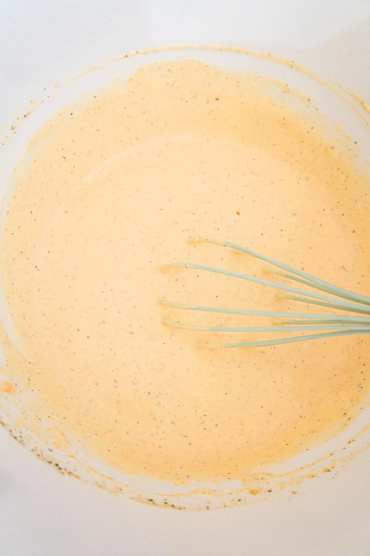 heavy cream and cheddar soup mixture whisked together in a large mixing bowl
