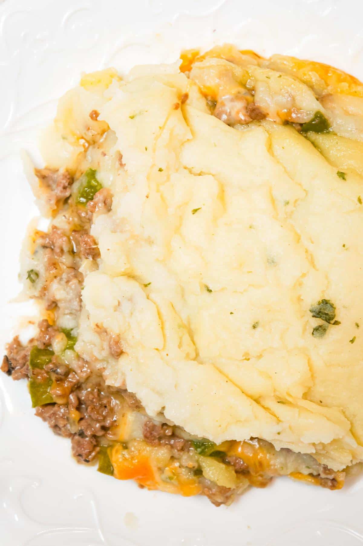 Philly Cheese Steak Shepherd's Pie is an easy casserole recipe loaded with ground beef, onions, green peppers, cheese and mashed potatoes.