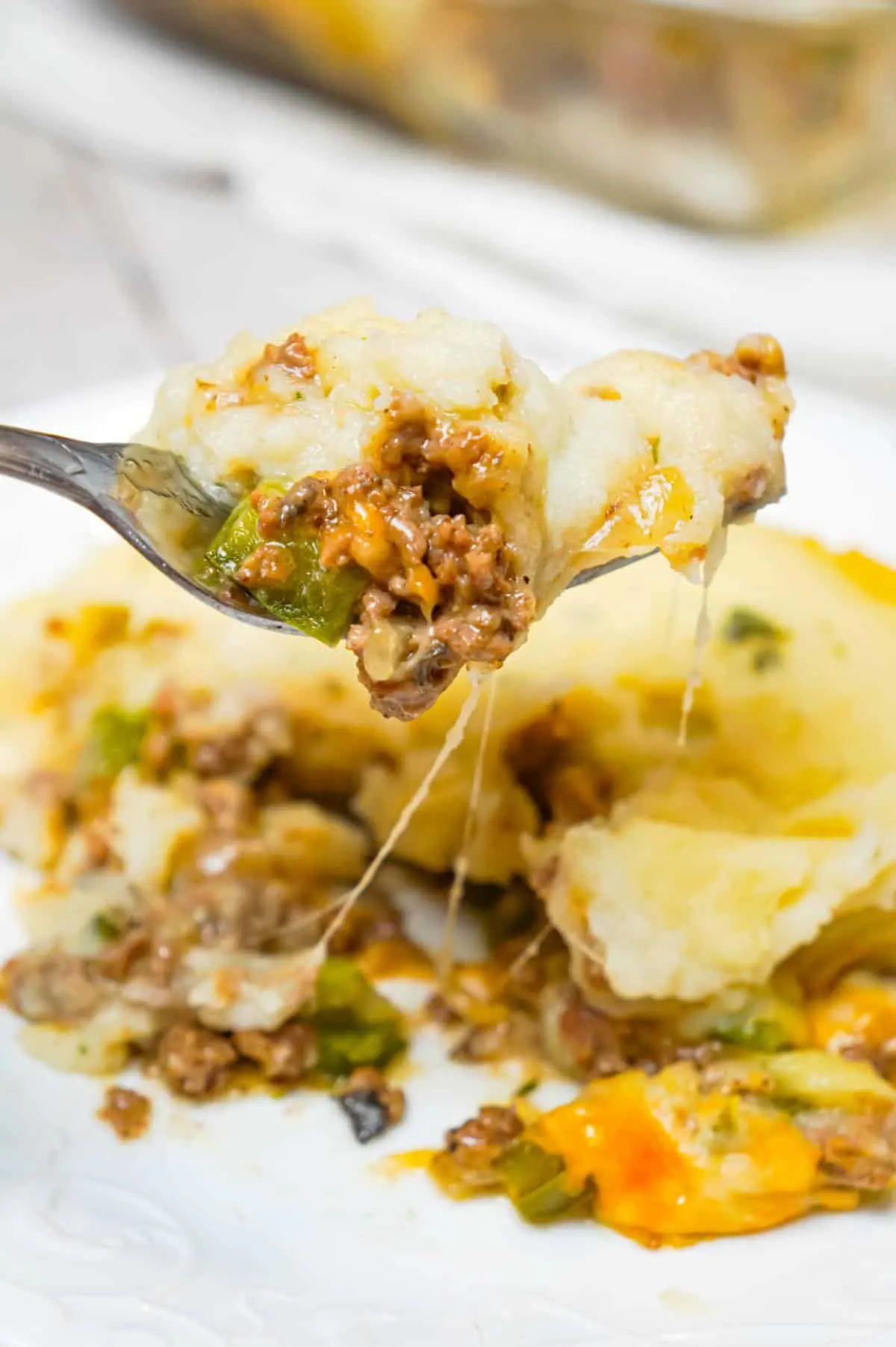 Philly Cheese Steak Shepherd's Pie is an easy casserole recipe loaded with ground beef, onions, green peppers, cheese and mashed potatoes.