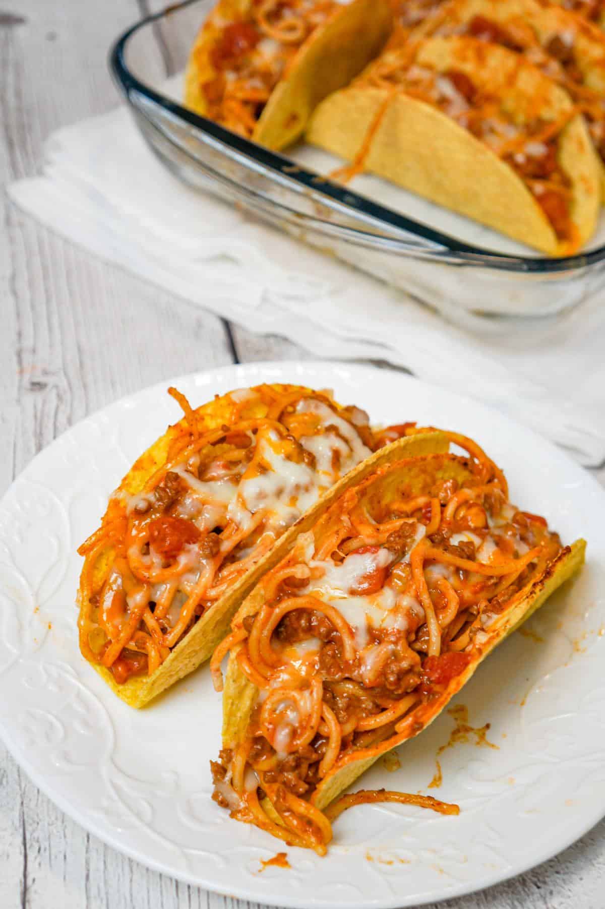 Spaghetti Tacos are an easy dinner recipe made with stand and stuff taco shells loaded with spaghetti and ground beef tossed in in tomato sauce with taco seasoning and baked with cheese.