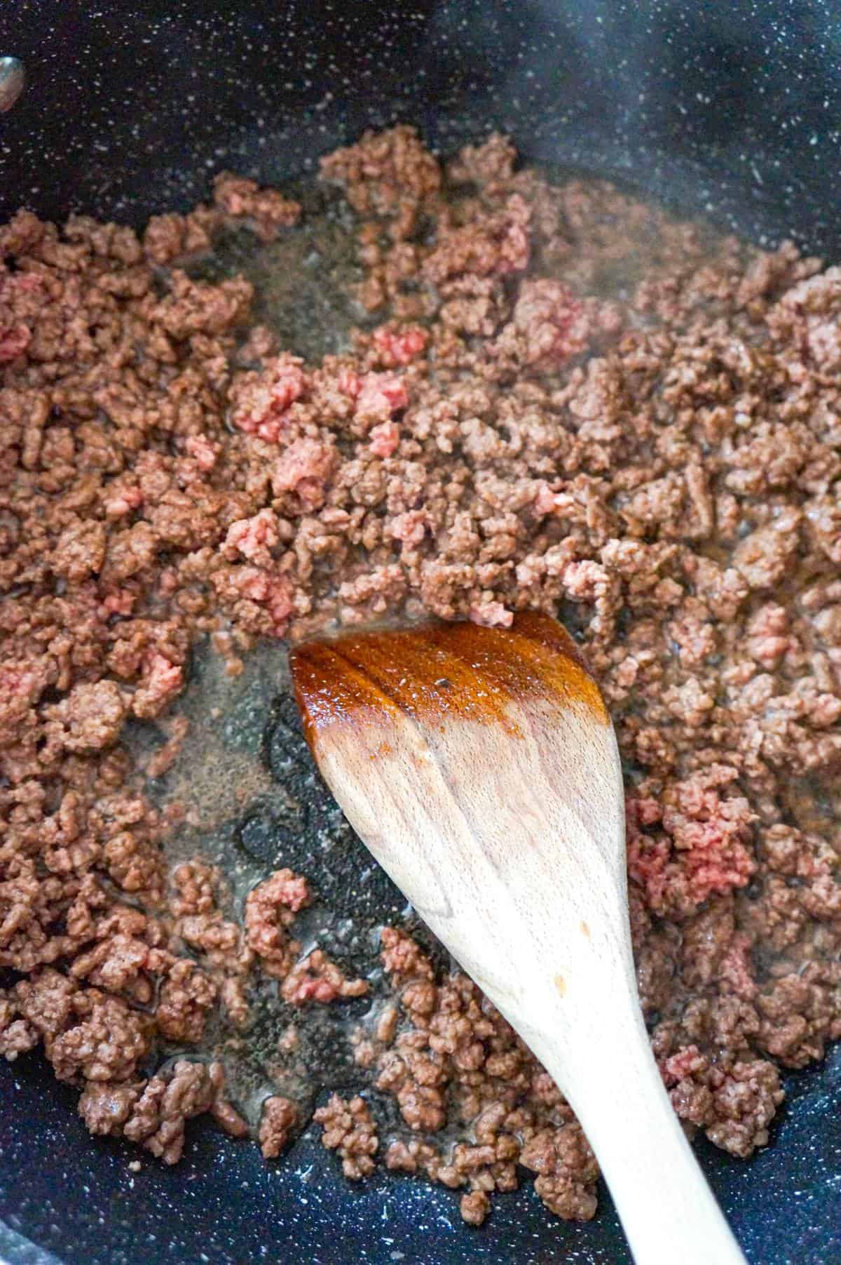 ground beef cooking in a saute pan