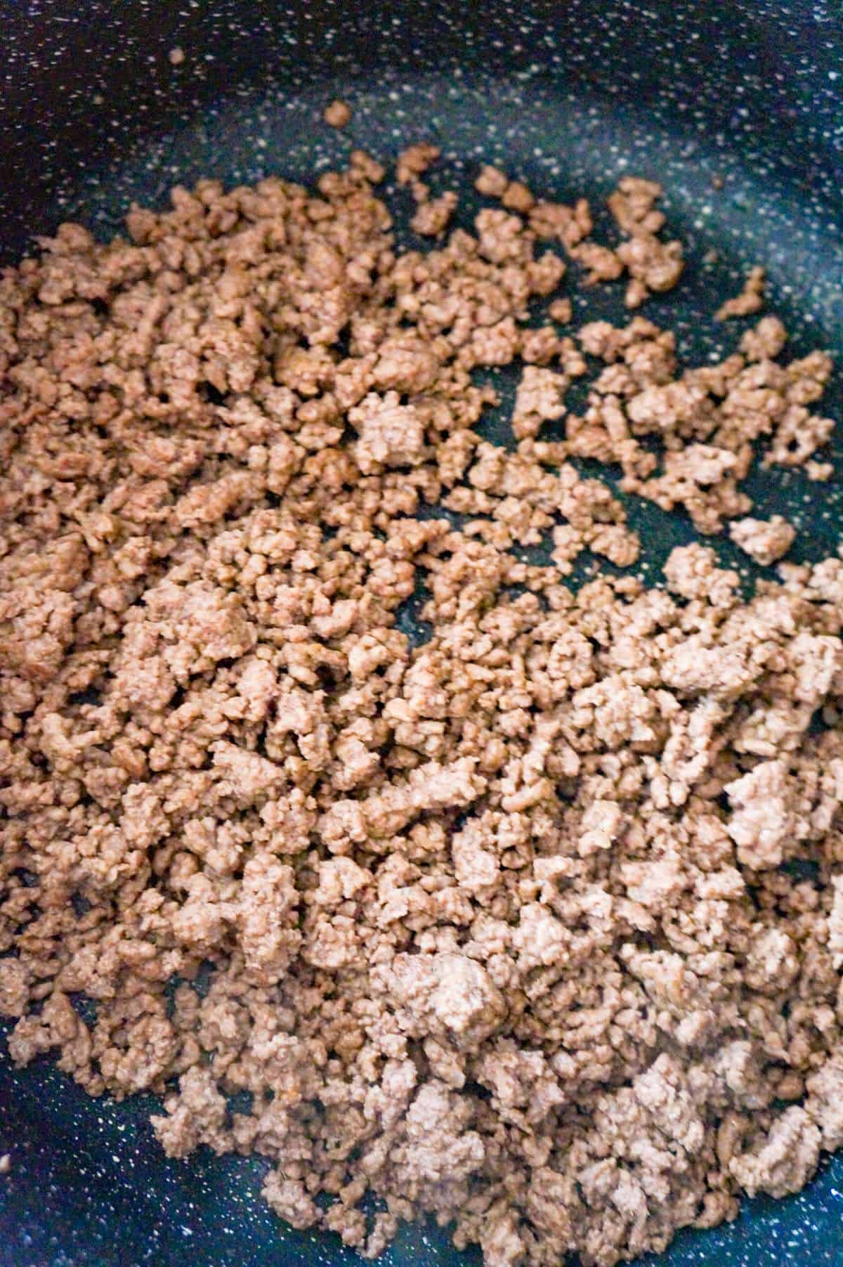 cooked ground beef in a saute pan
