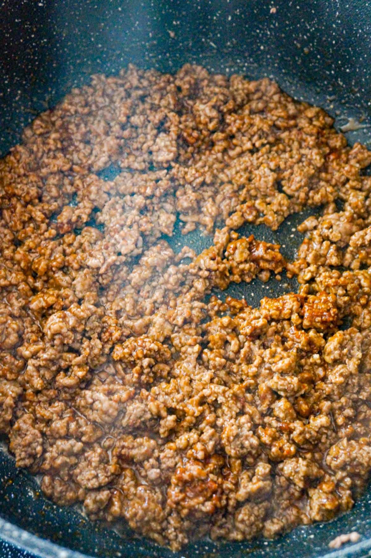 cooked ground beef in taco seasoning in a saute pna