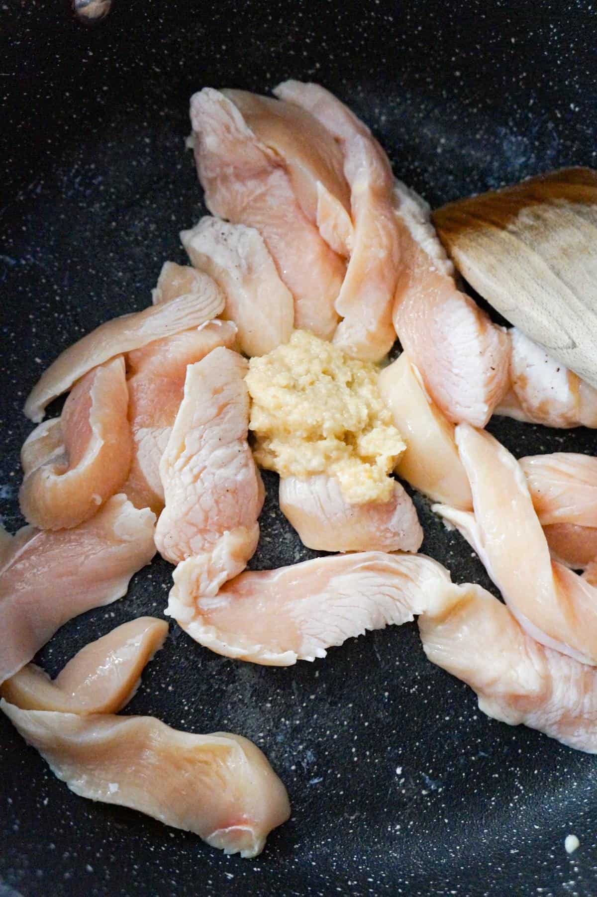 chicken breast strips and garlic puree in a sautee pan