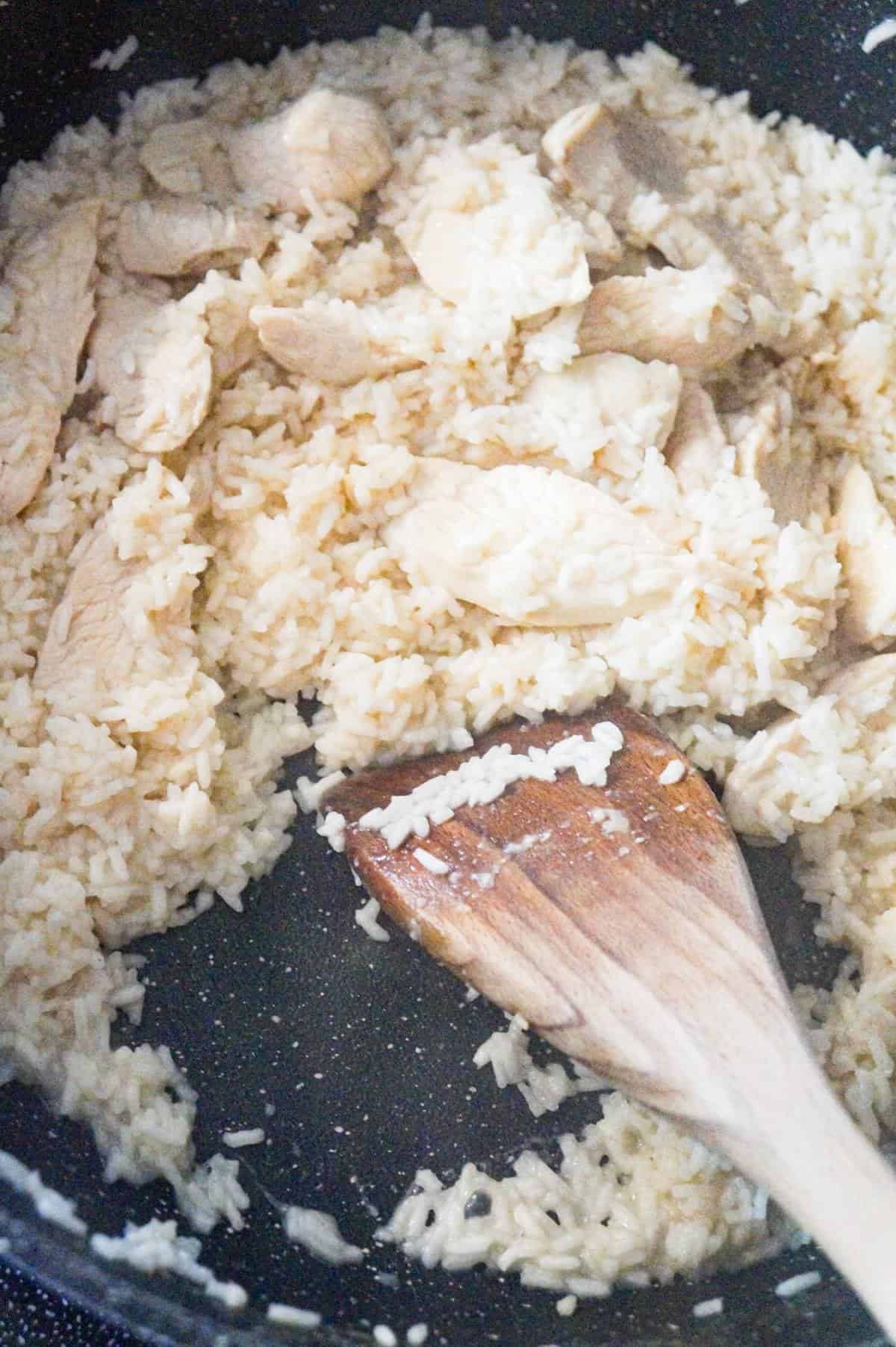 cooked chicken and rice in a saute pan