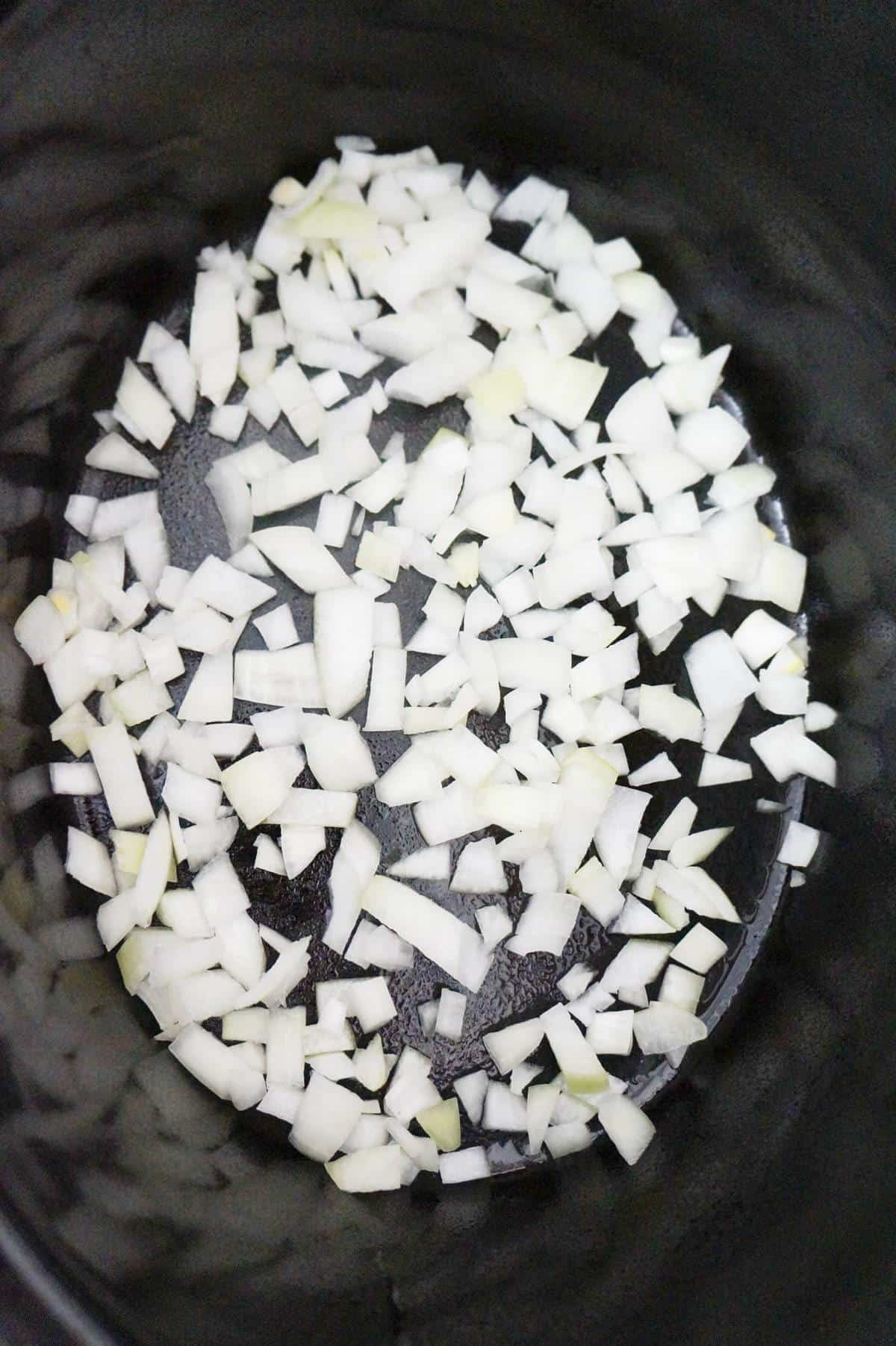 diced onions in a crock pot.