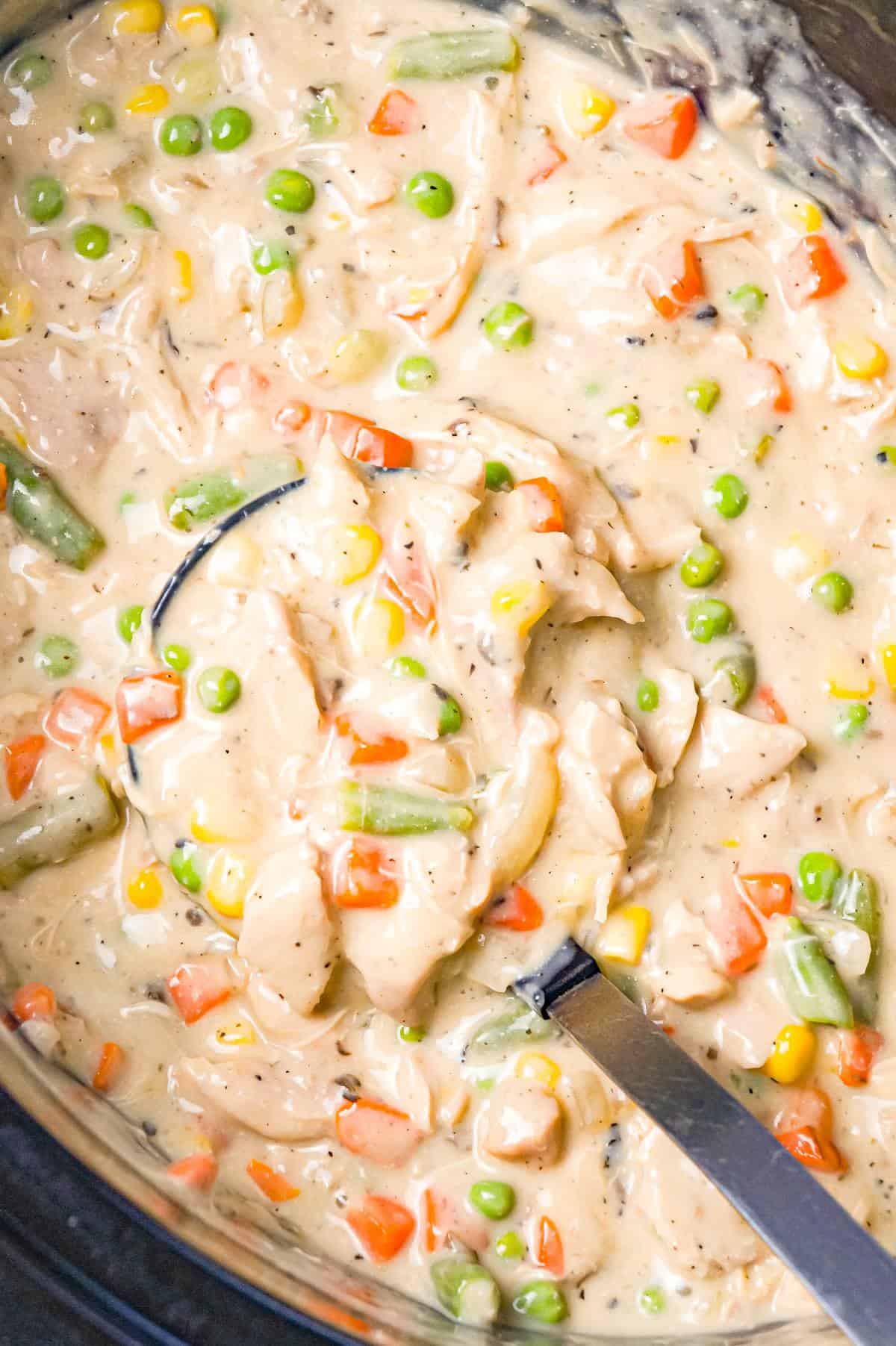 Crock Pot Chicken Pot Pie is an easy slow cooker dinner recipe made with boneless, skinless chicken thighs, cream of mushroom soup, cream of chicken soup and mixed veggies and topped with Pillsbury biscuits.