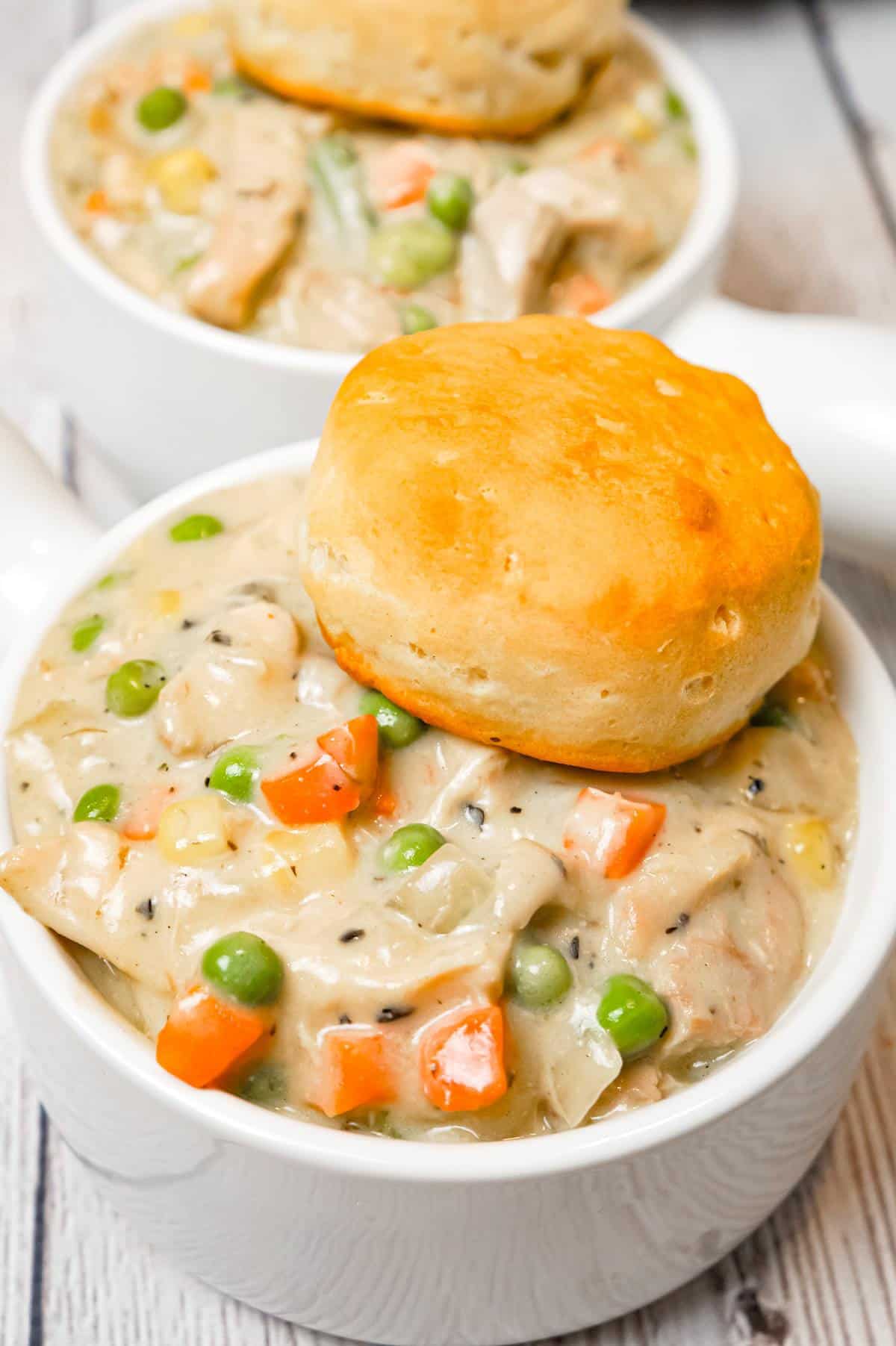 Crock Pot Chicken Pot Pie is an easy slow cooker dinner recipe made with boneless, skinless chicken thighs, cream of mushroom soup, cream of chicken soup and mixed veggies and topped with Pillsbury biscuits.