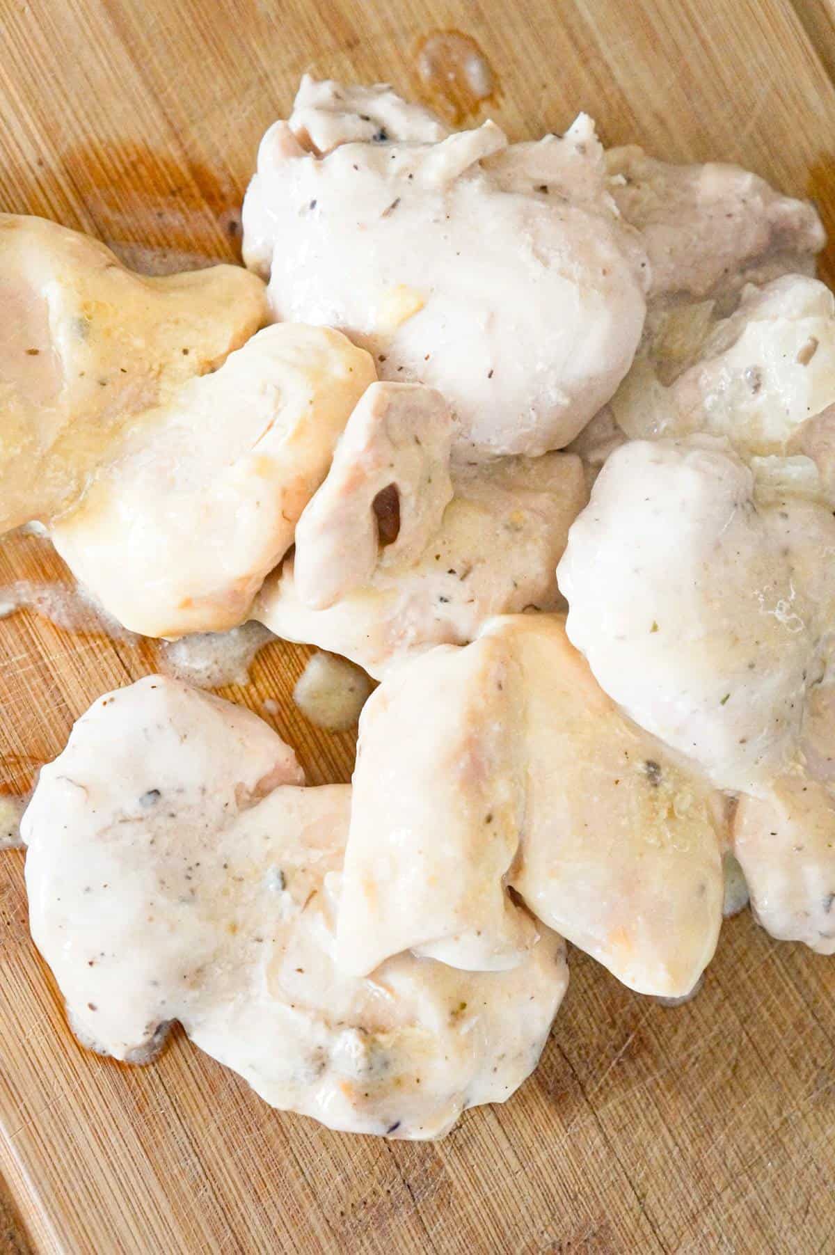 cooked chicken thighs on a cutting board