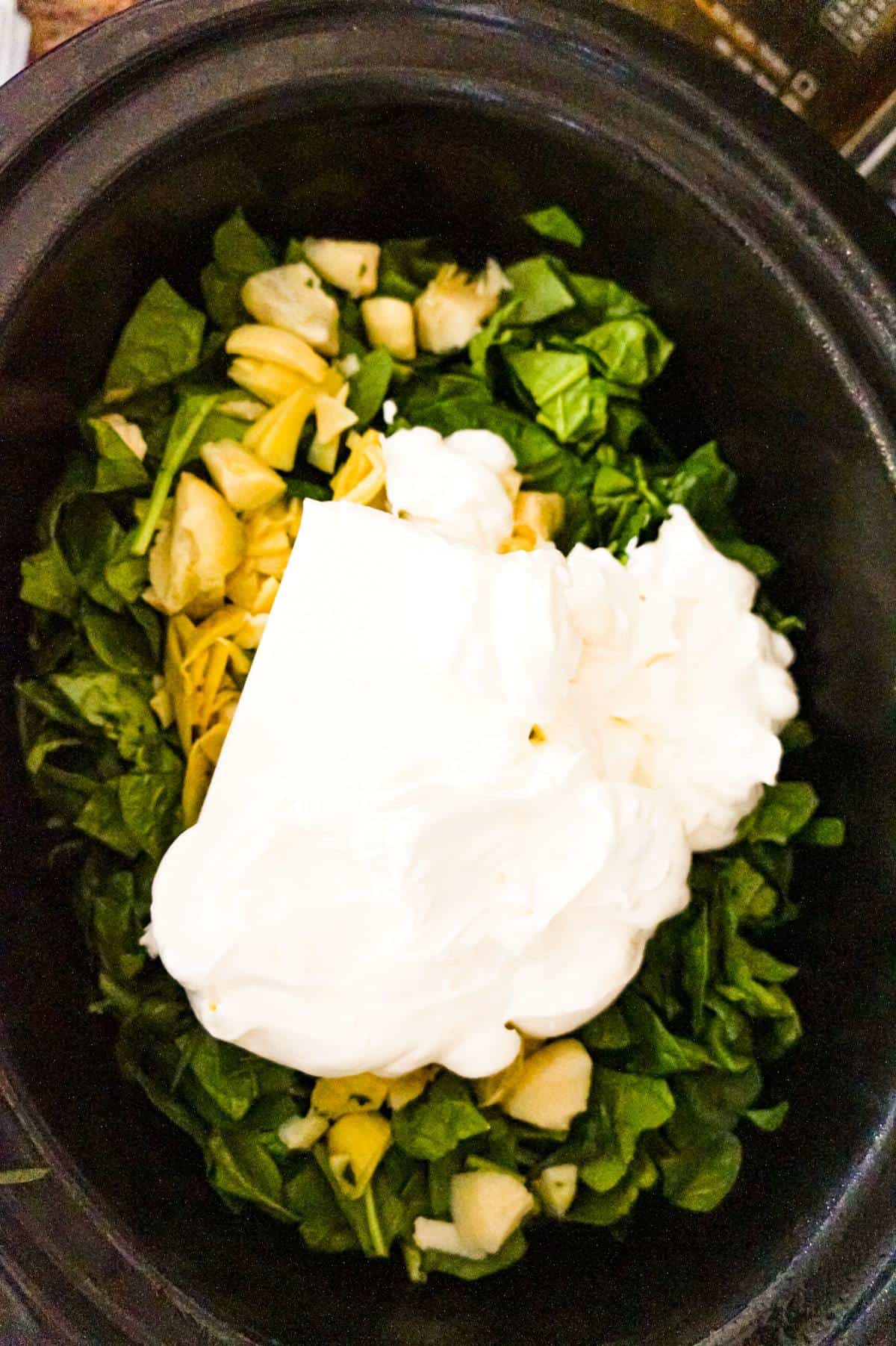 sour cream, cream cheese, chopped artichoke and chopped spinach in a crock pot
