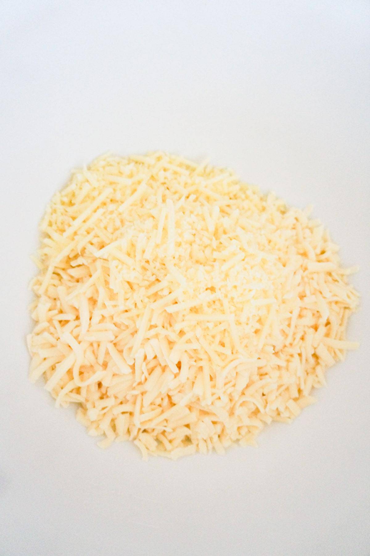 shredded mozzarella and shredded Parmesan in a mixing bowl