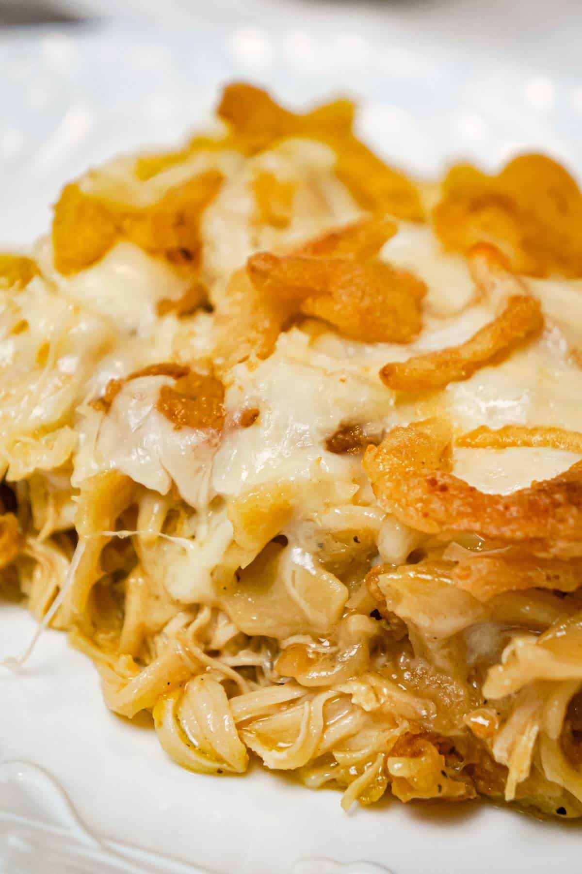 French Onion Chicken Casserole is a hearty casserole recipe loaded with shredded chicken, egg noodles, onion soup mix, cream of chicken soup, mozzarella cheese, parmesan cheese and French's crispy fried onions.