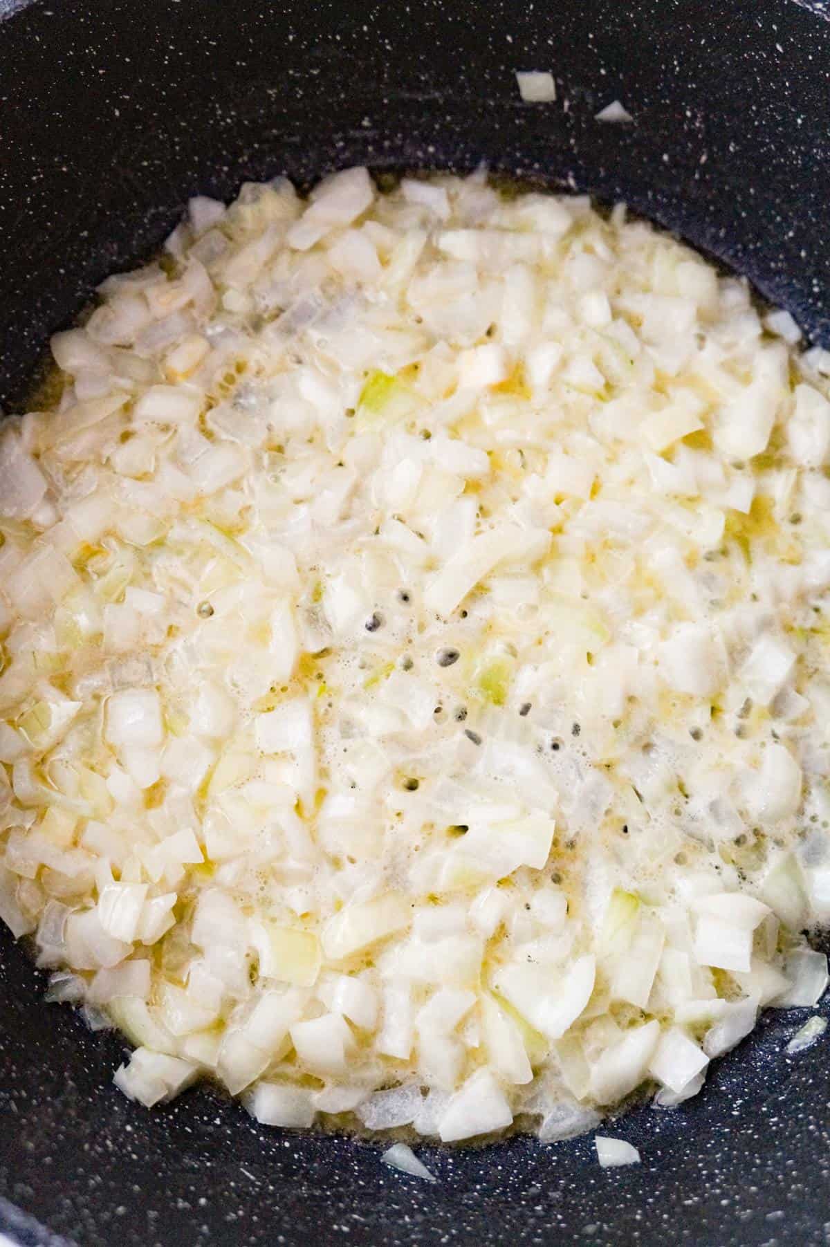 diced onions cooking in butter in a pot