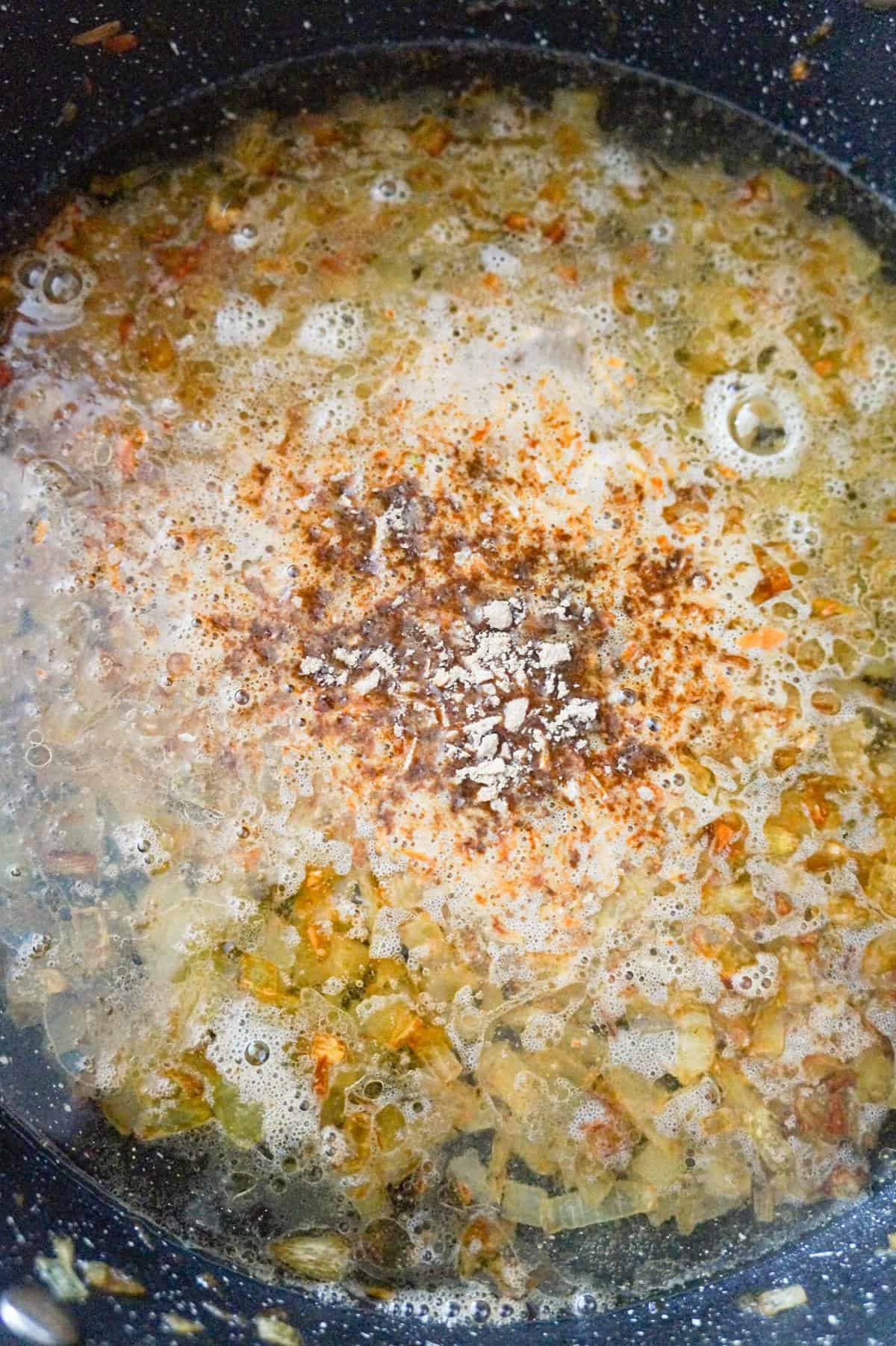 onion soup mix added to pot with water and cooked onions