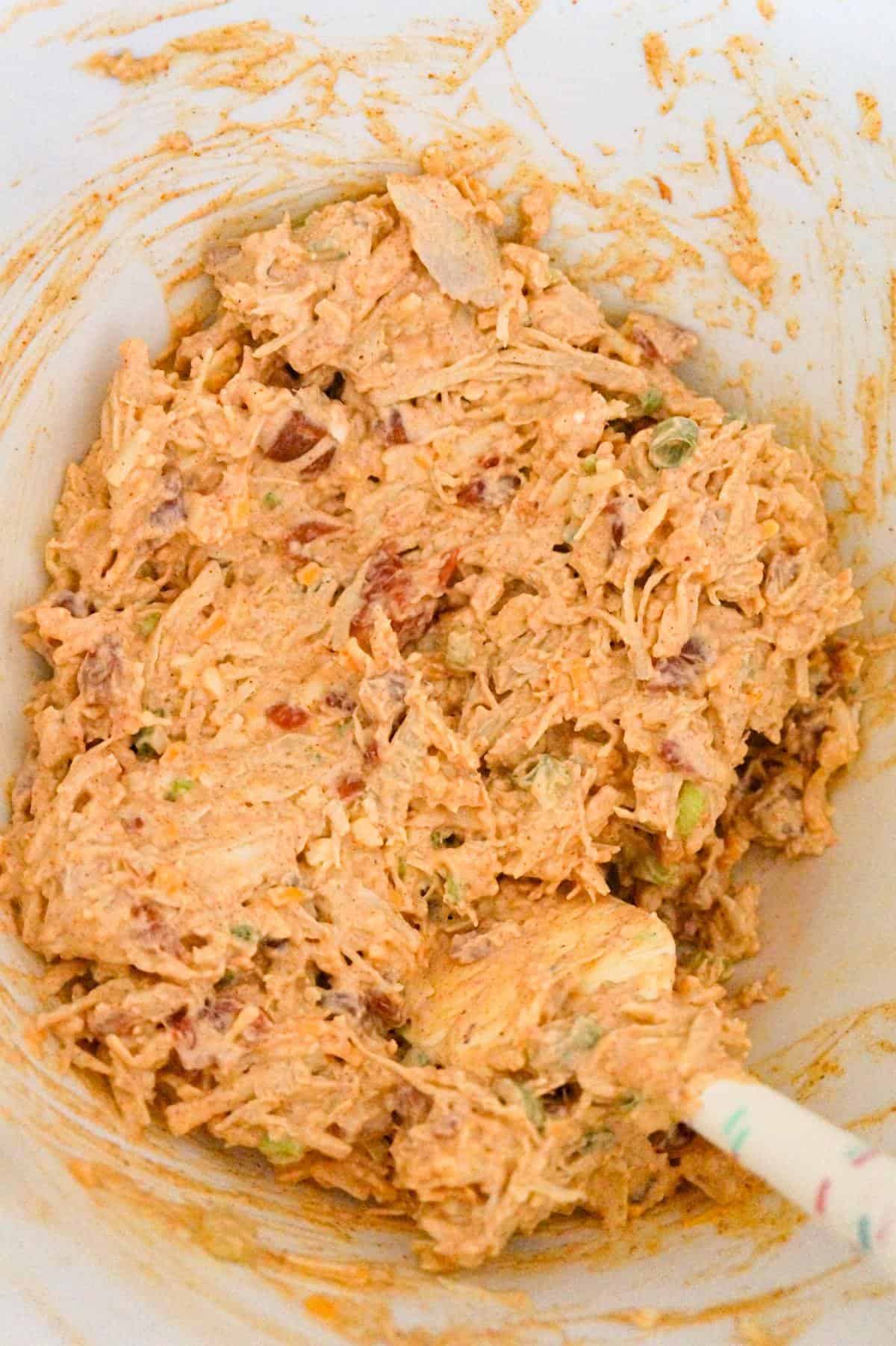 Mexican chicken casserole mixture in a mixing bowl