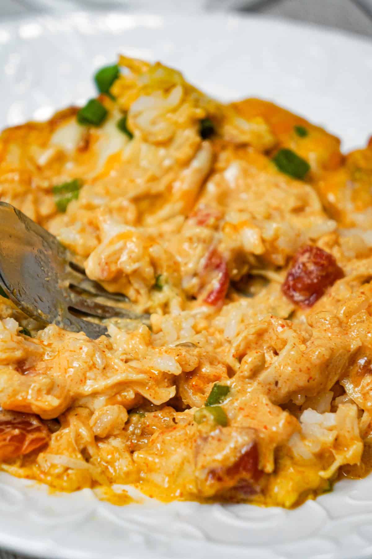 Mexican Chicken Casserole is an easy dinner recipe loaded with Minute rice, shredded rotisserie chicken, Rotel diced tomatoes and green chilies, sour cream and shredded cheese.