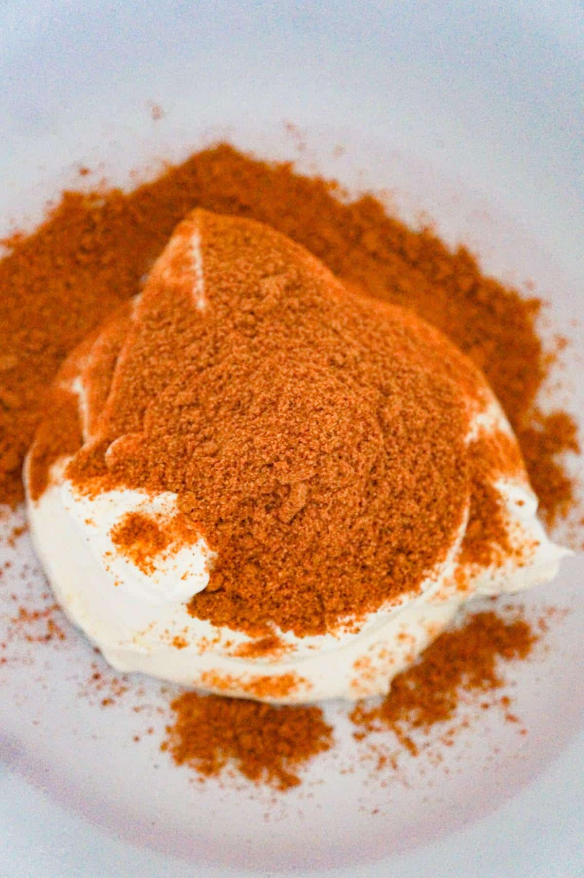 taco seasoning on top of sour cream in a mixing bowl