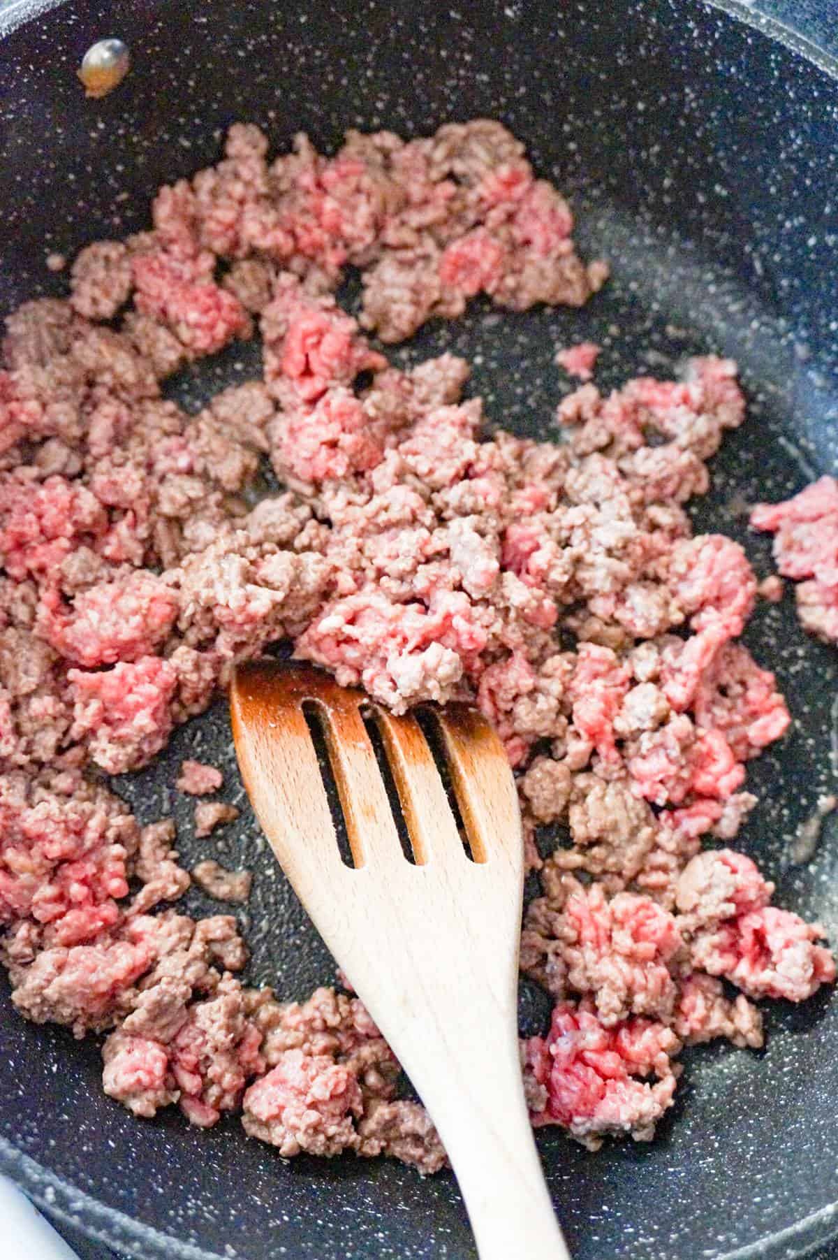 ground beef cooking in a saute pan